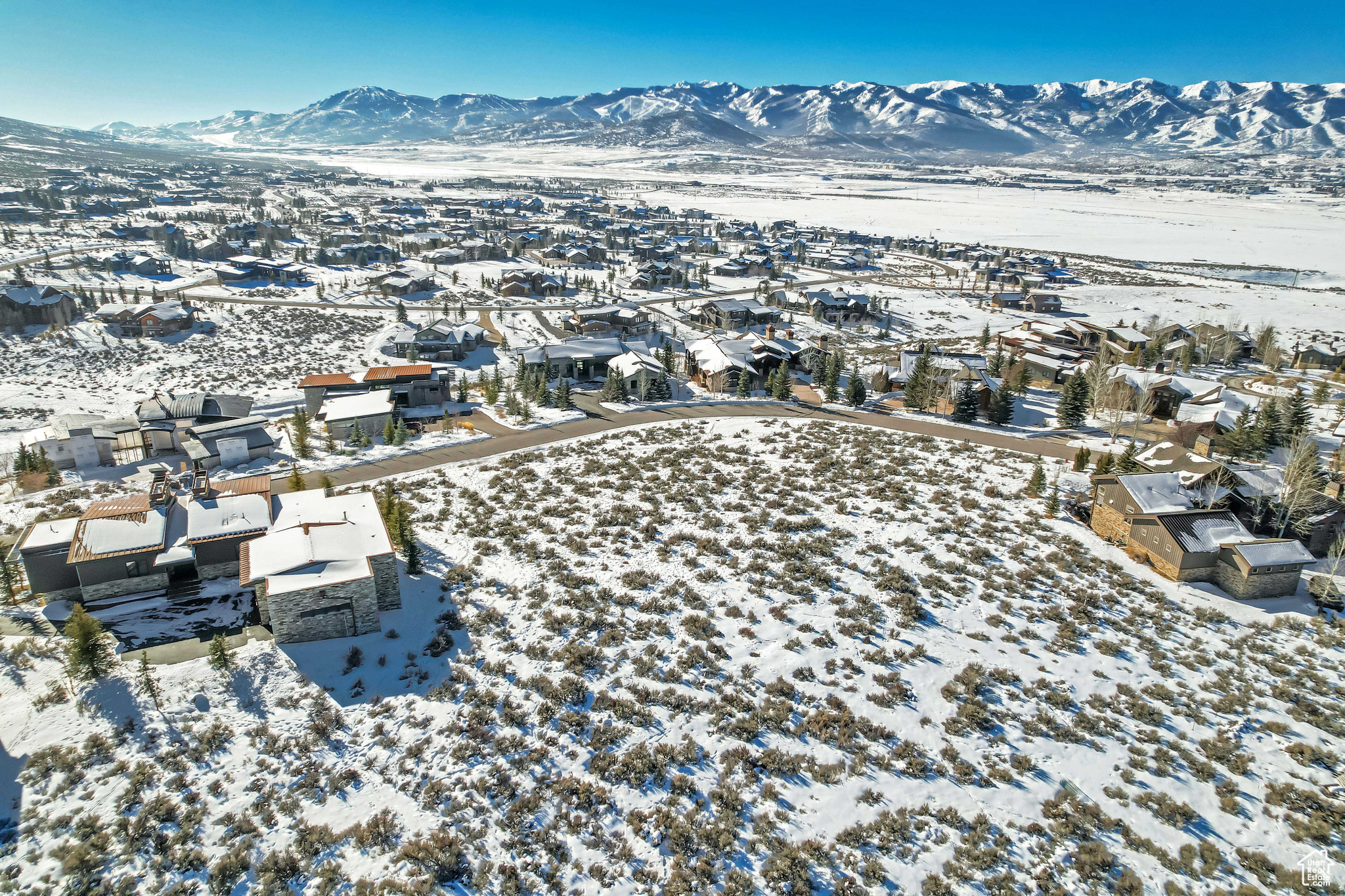 Snowy aerial view featuring a mountain view