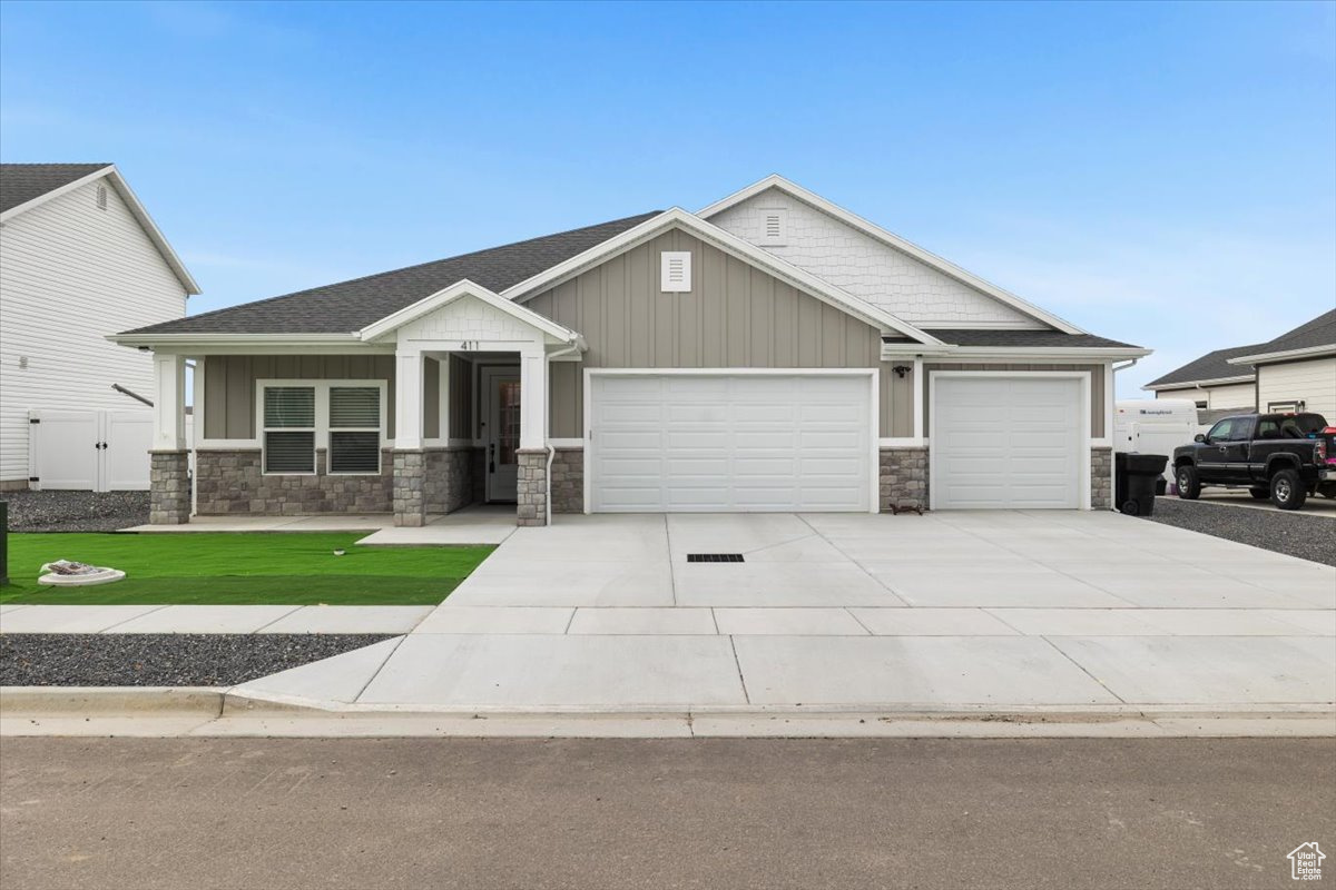 Craftsman-style house with a garage and a front yard