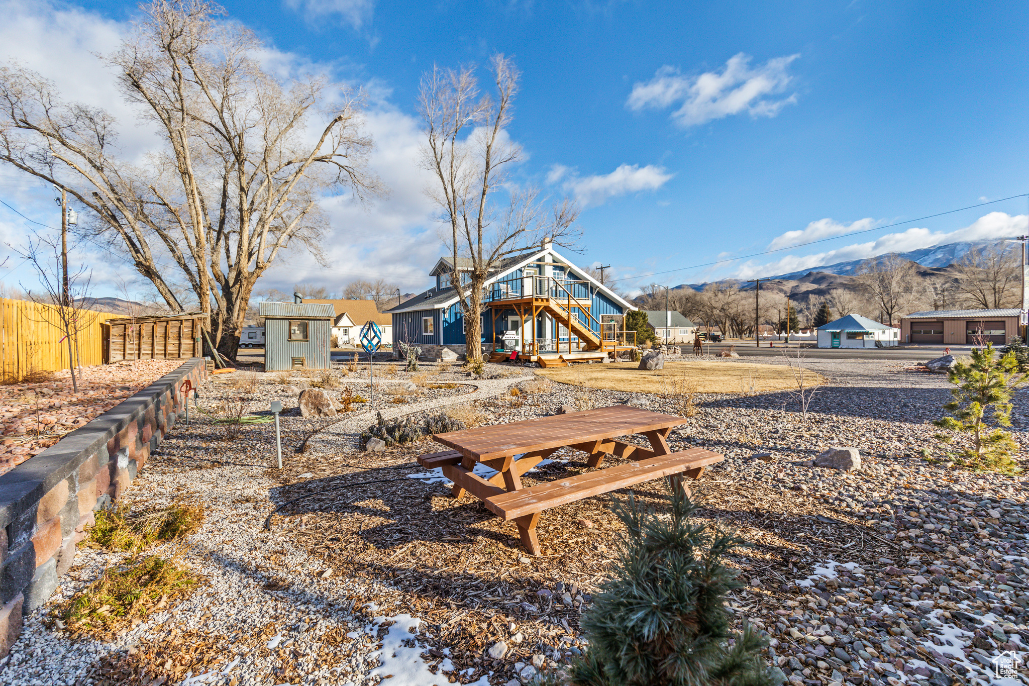 View of yard with a storage shed and a deck with mountain view