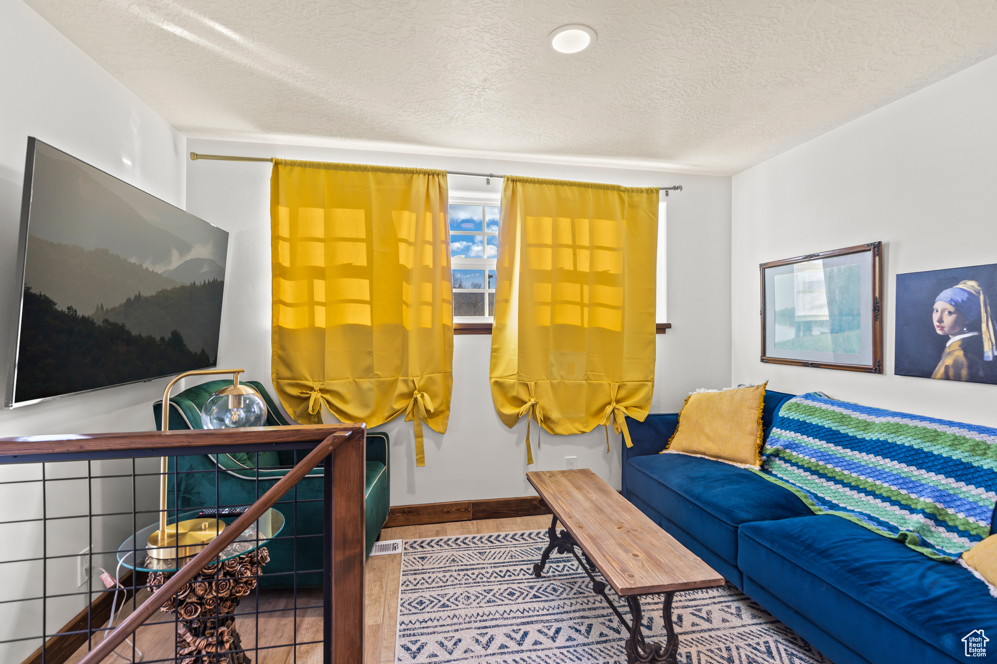 Tiled living room featuring a textured ceiling