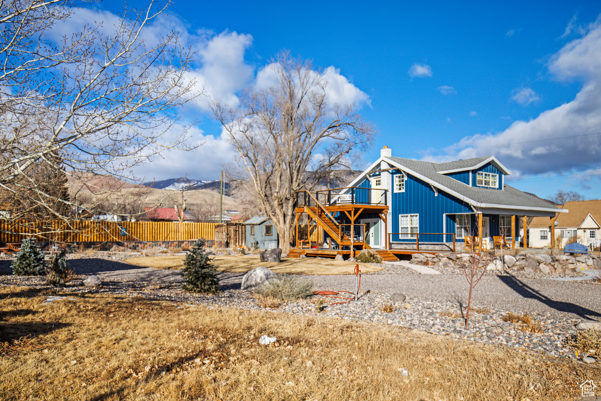 Rear view of house with a deck with mountain view and an outbuilding