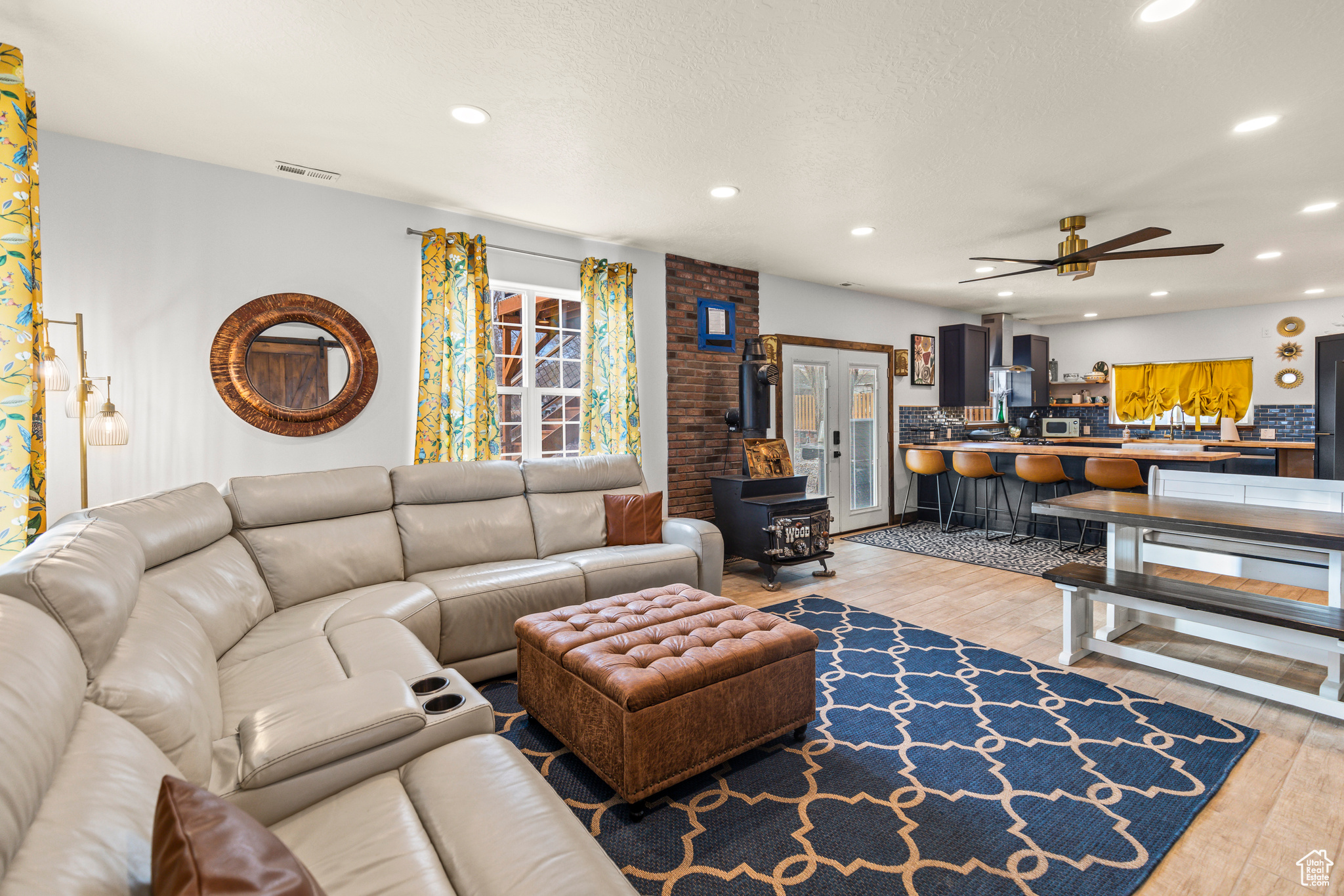 Living room with ceiling fan and light wood-type flooring