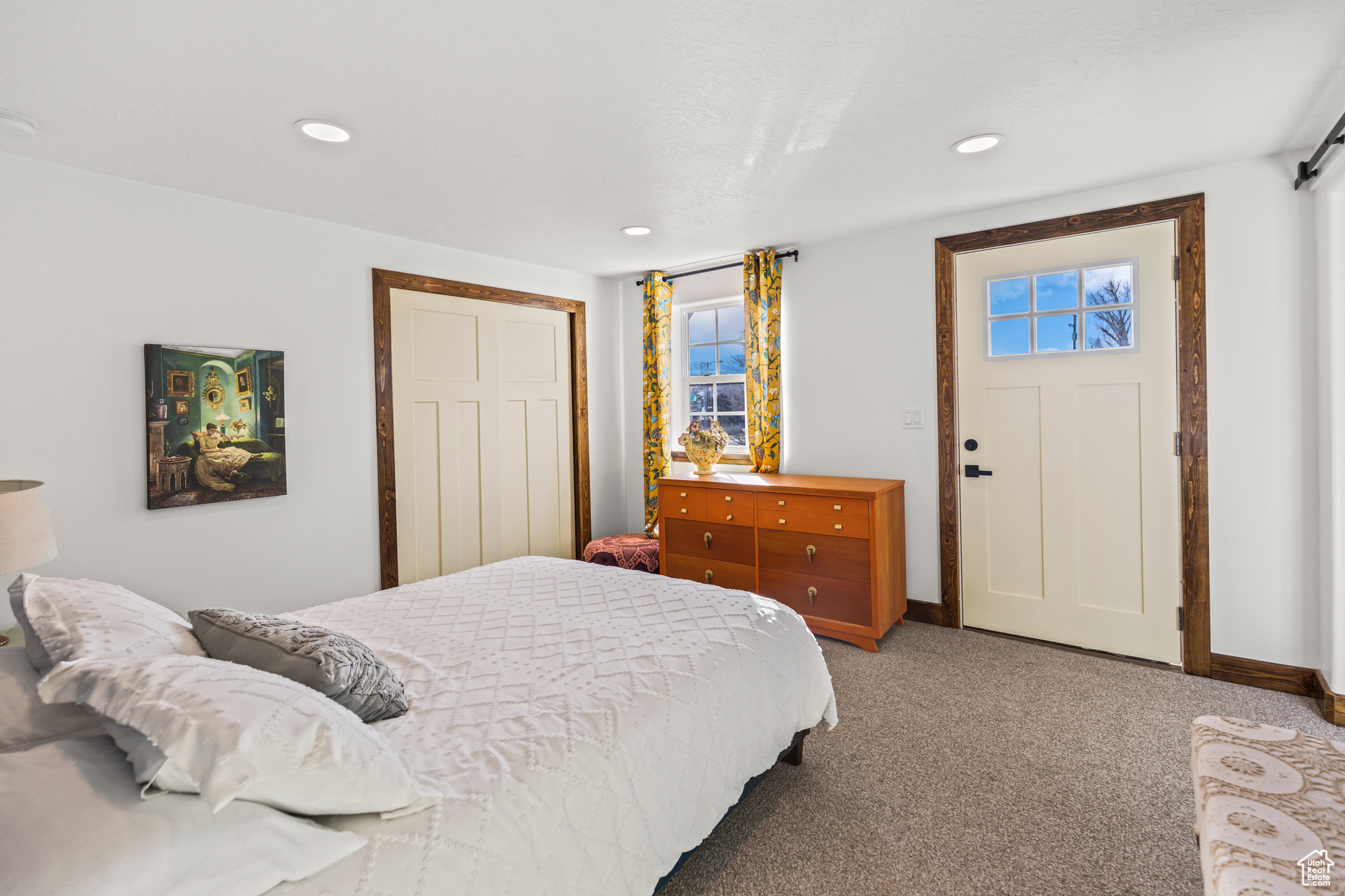 Carpeted bedroom with multiple windows