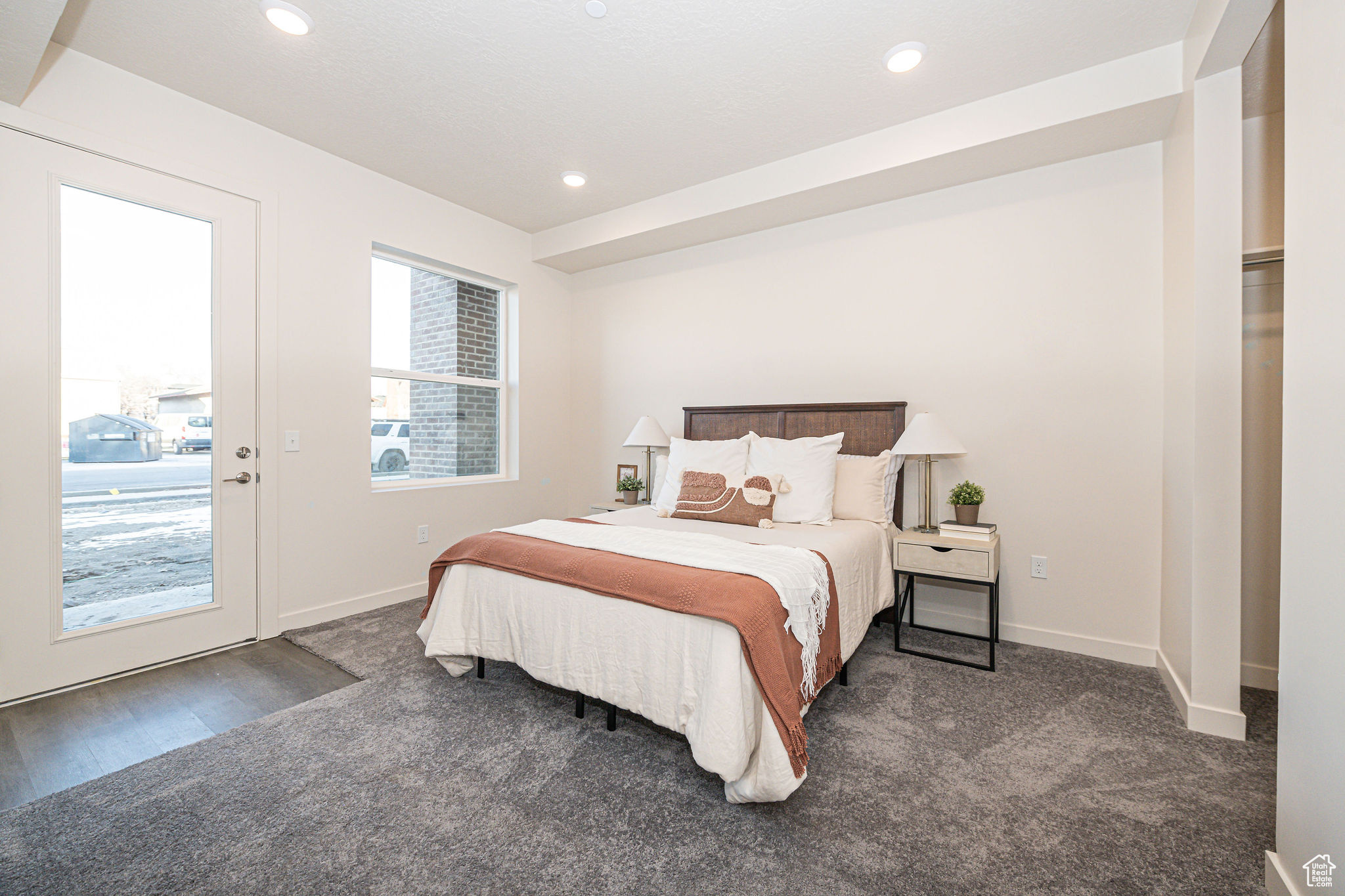 Bedroom featuring access to outside and dark carpet