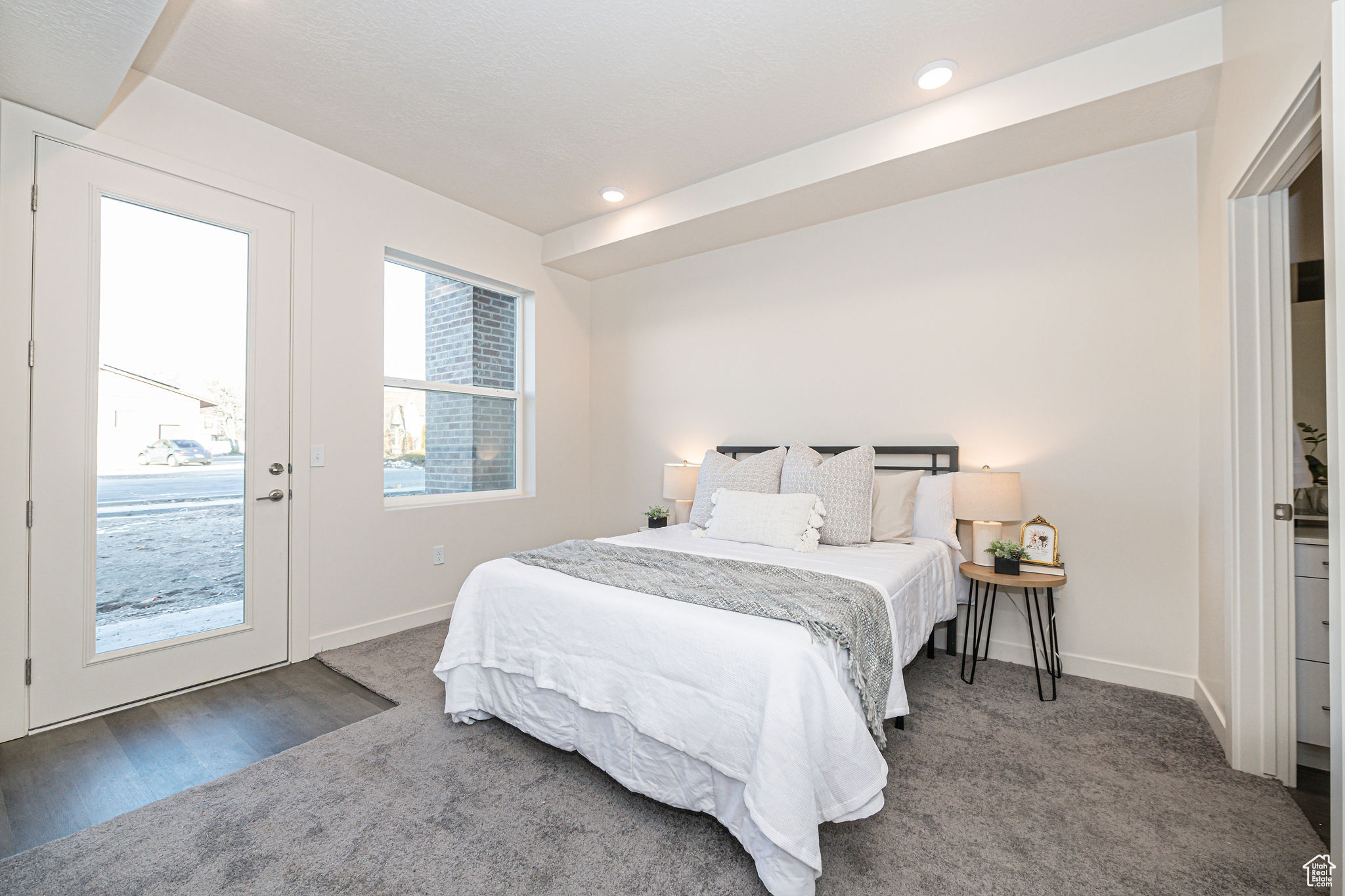 Bedroom featuring access to exterior and dark colored carpet