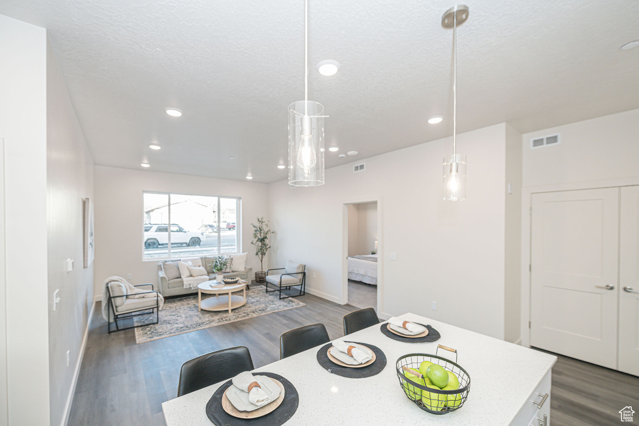 Dining space with dark hardwood / wood-style flooring and a textured ceiling