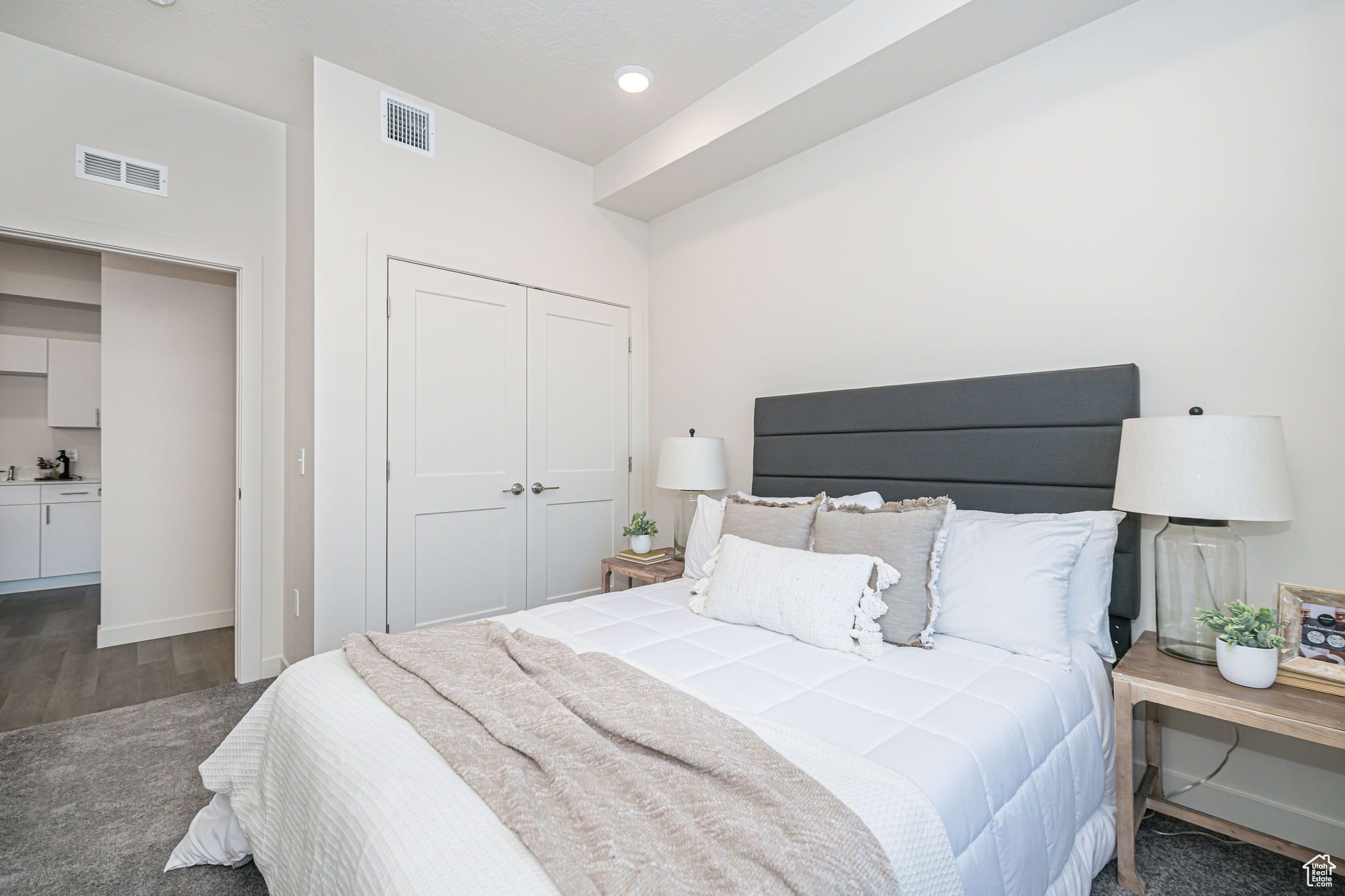 Bedroom with dark wood-type flooring and a closet