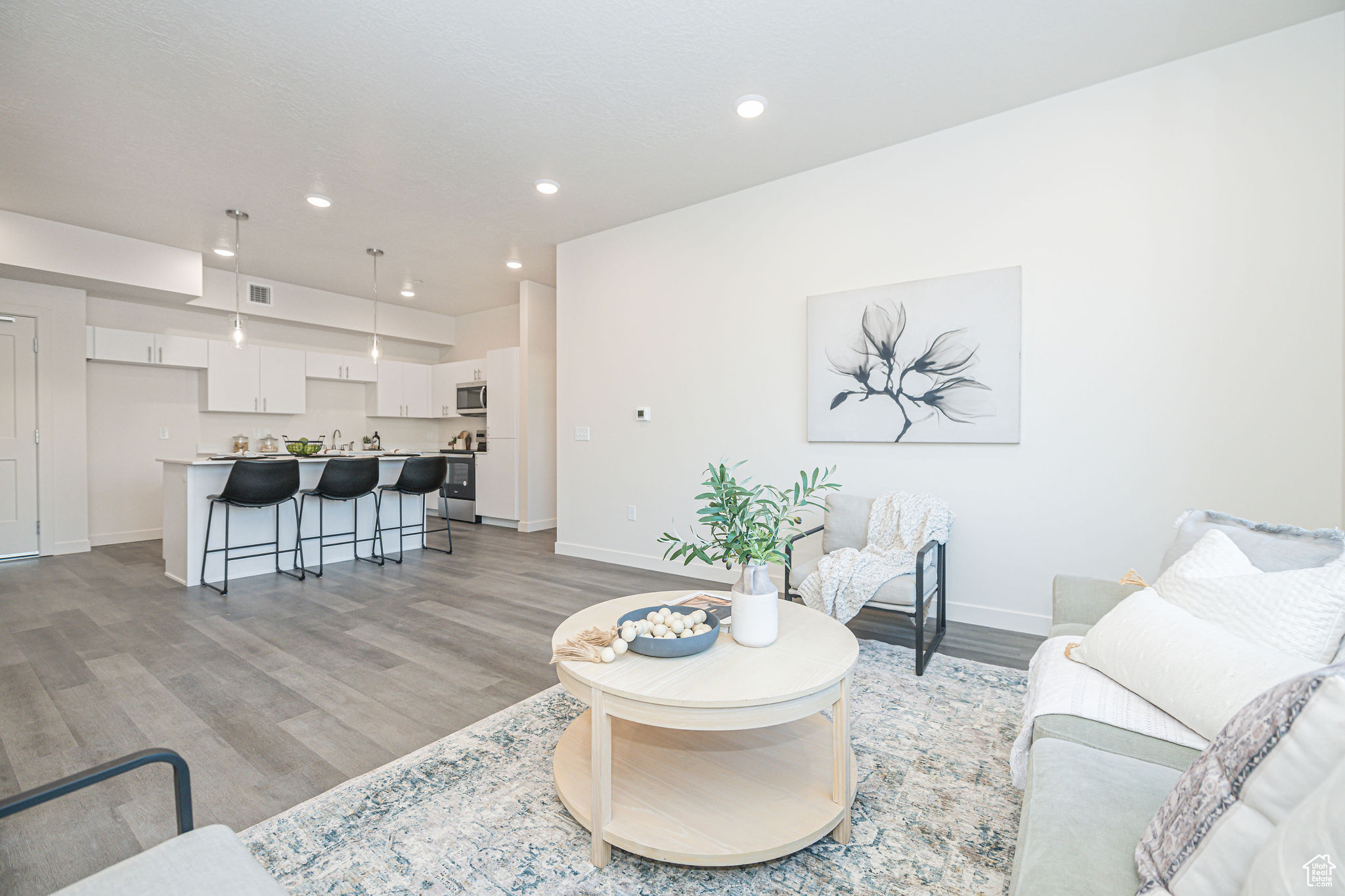 Living room featuring light wood-type flooring and sink