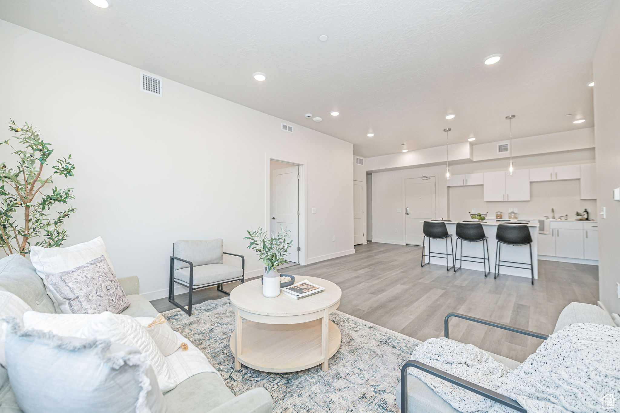 Living room with light hardwood / wood-style flooring