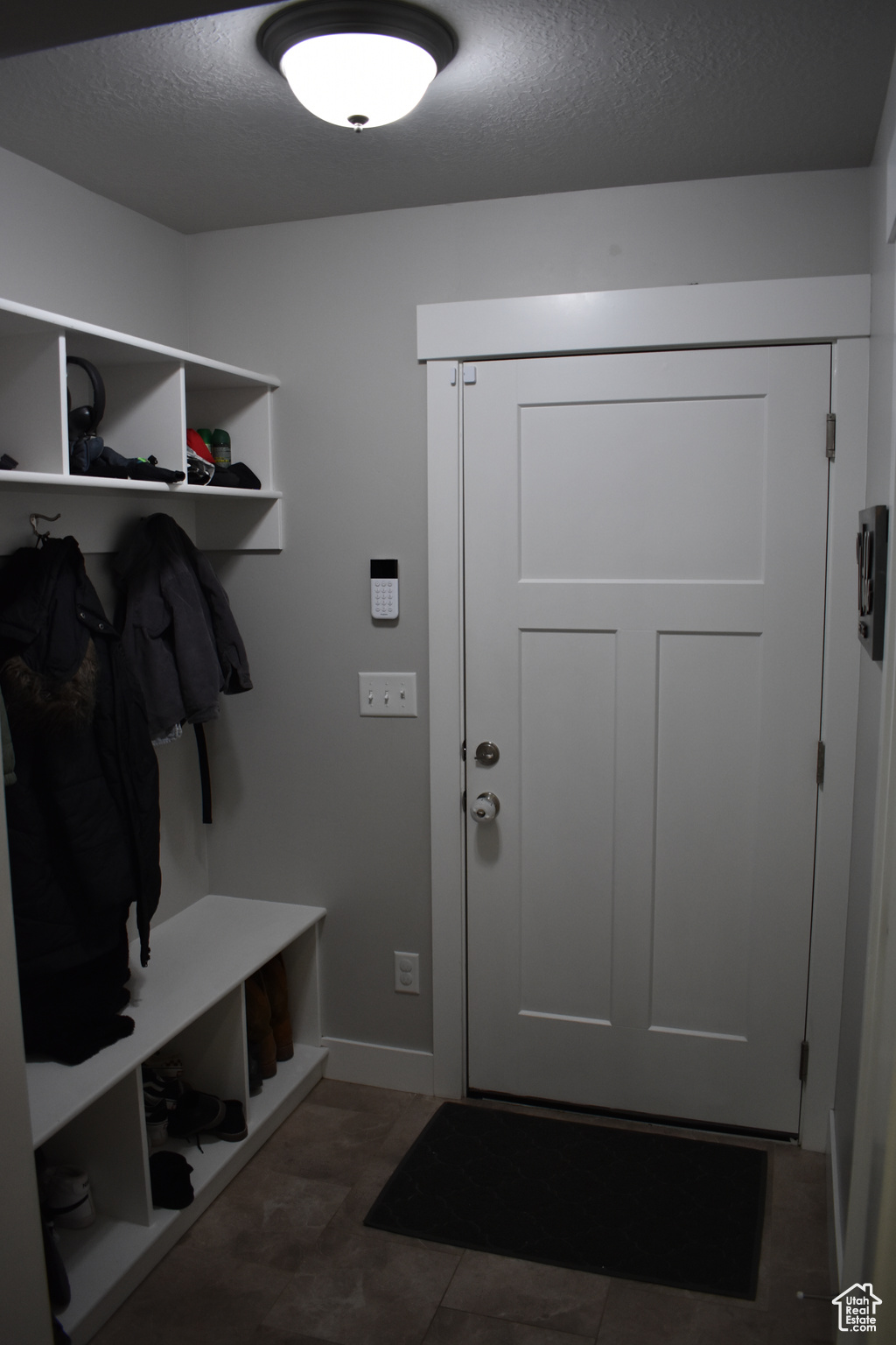 Mudroom with a textured ceiling