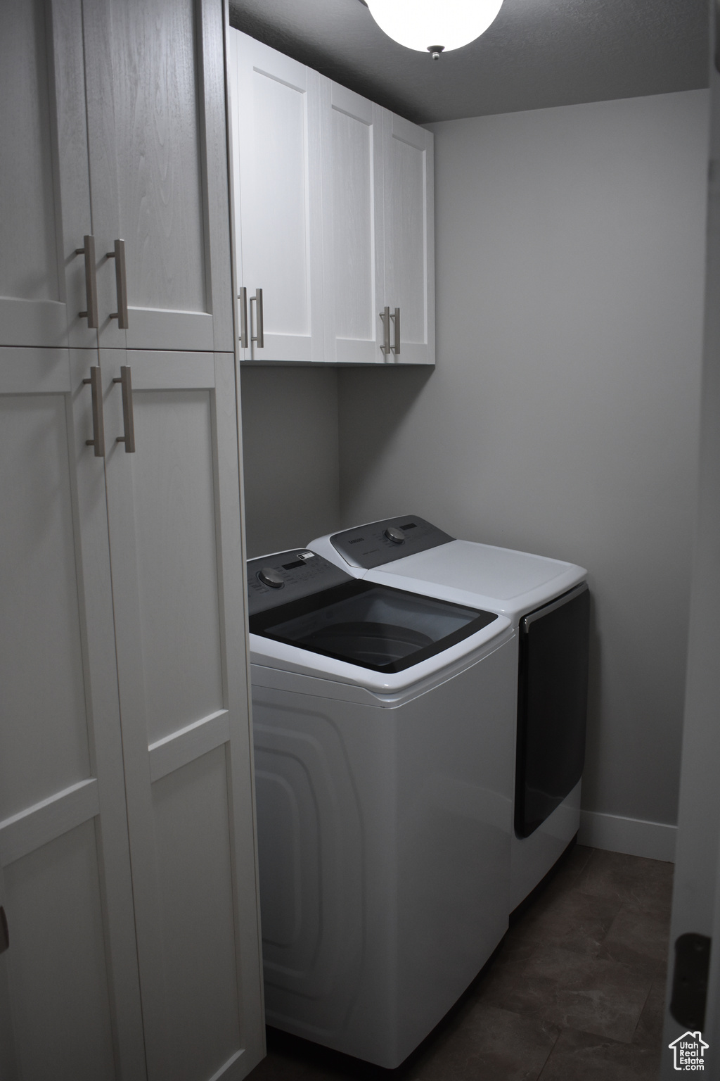 Laundry room with washing machine and clothes dryer and cabinets