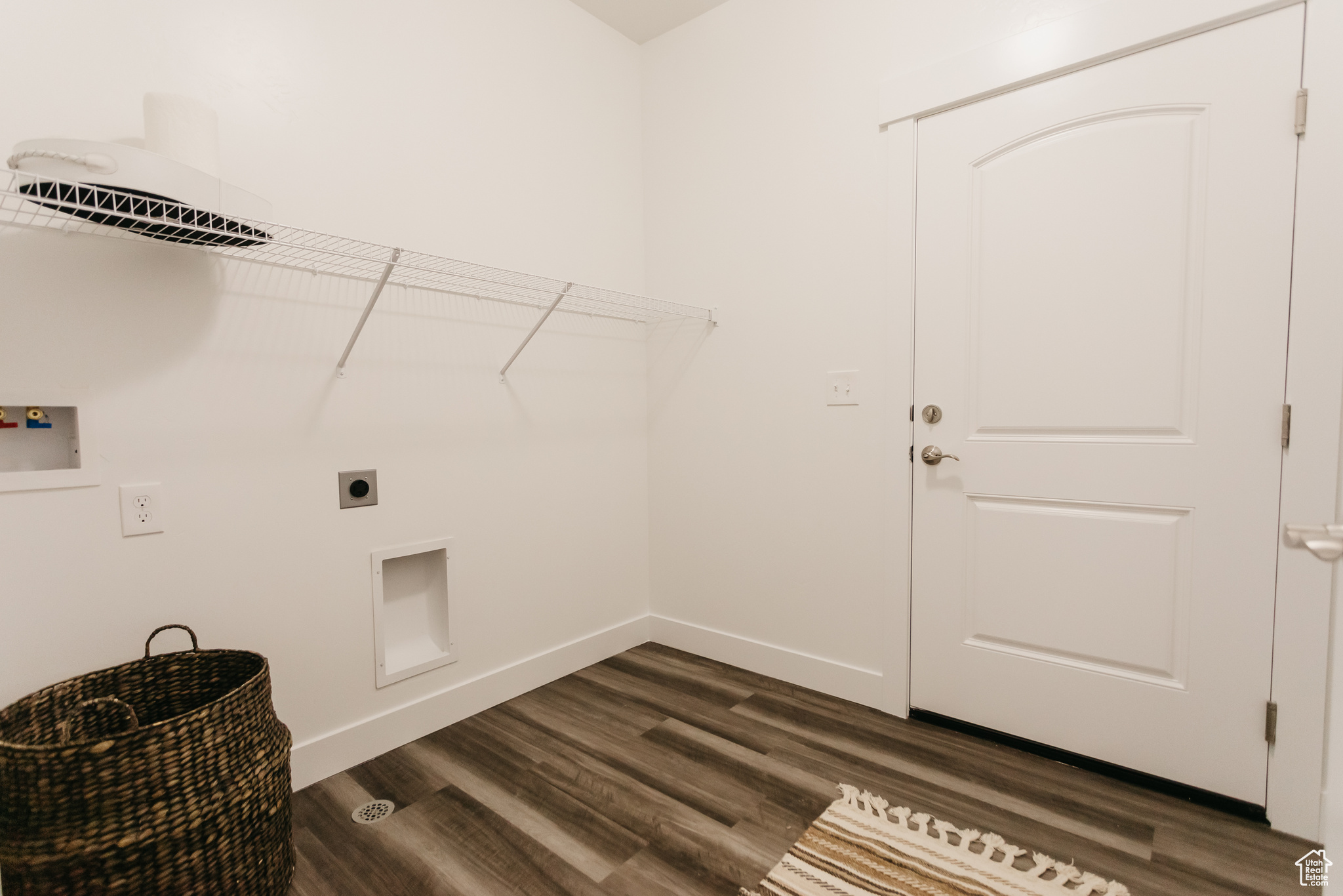 Washroom featuring washer hookup, dark hardwood / wood-style floors, and hookup for an electric dryer