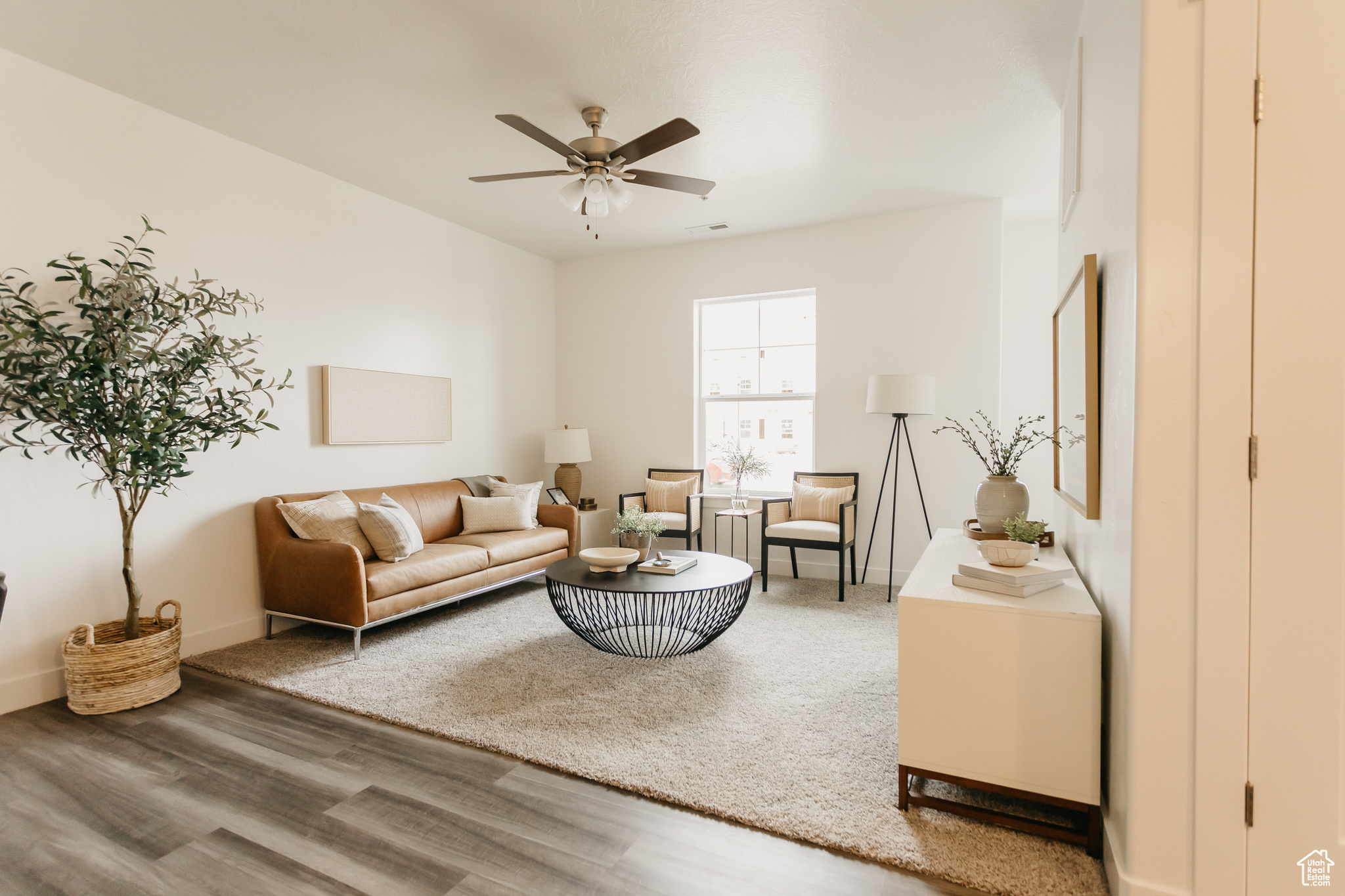 Living room featuring ceiling fan and hardwood / wood-style floors