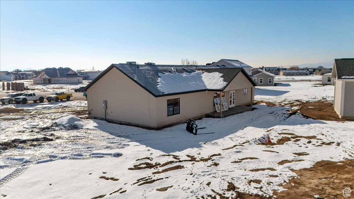 View of snow covered rear of property