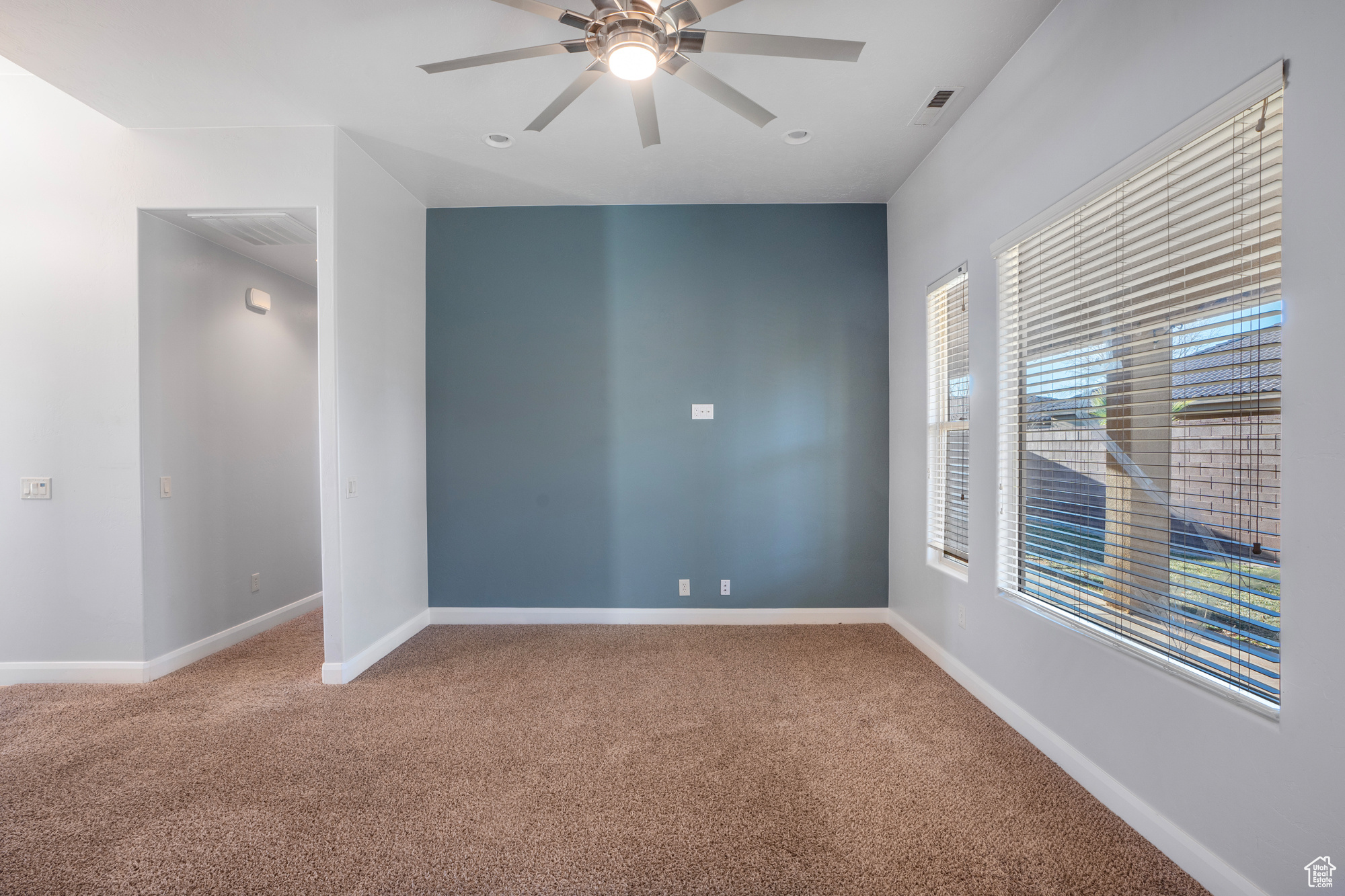 Unfurnished room featuring ceiling fan and carpet floors