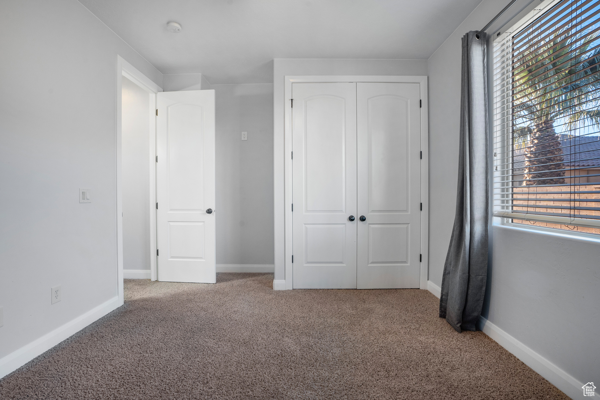 Unfurnished bedroom with a closet and carpet flooring