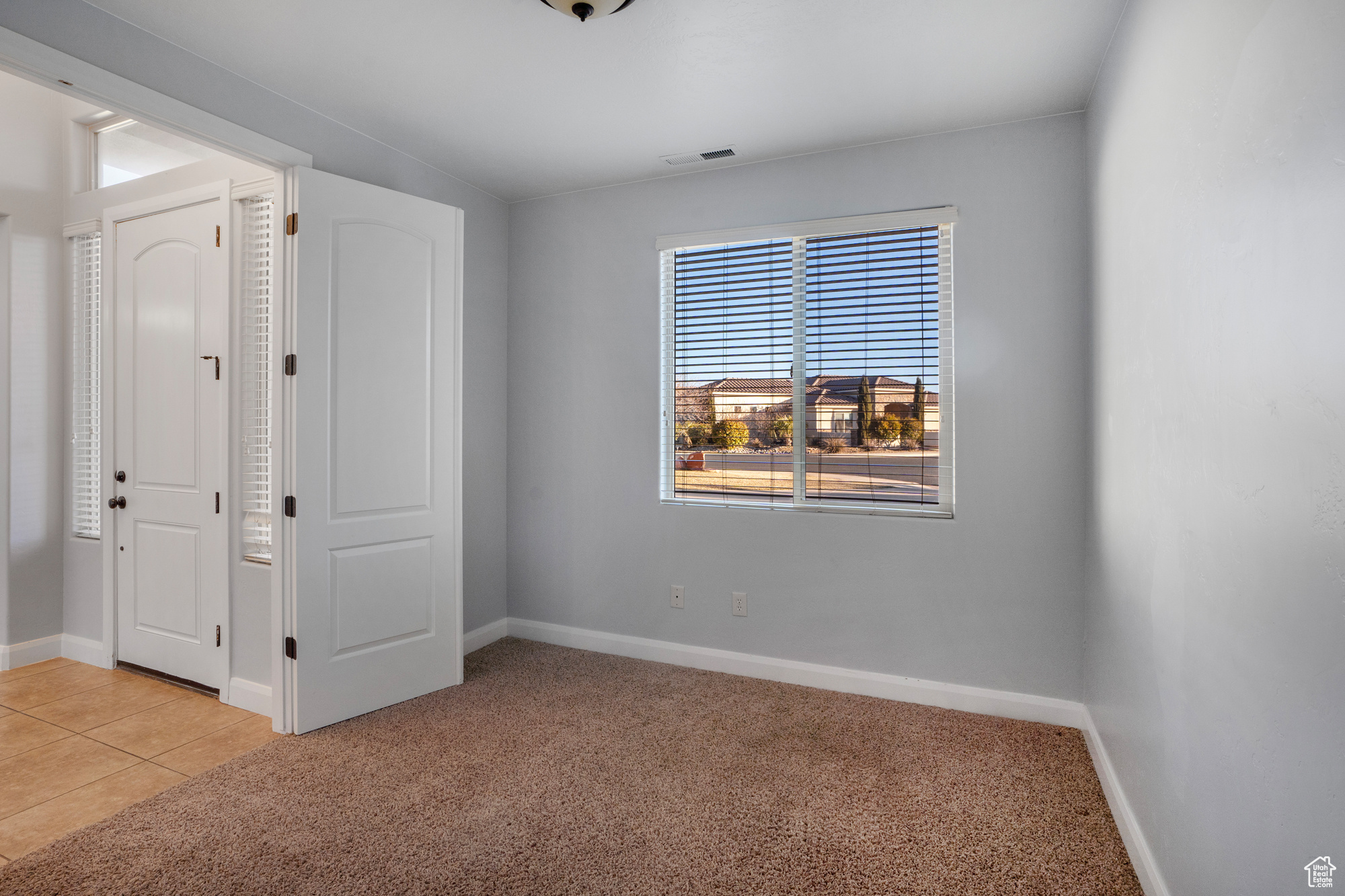 Unfurnished bedroom with light carpet