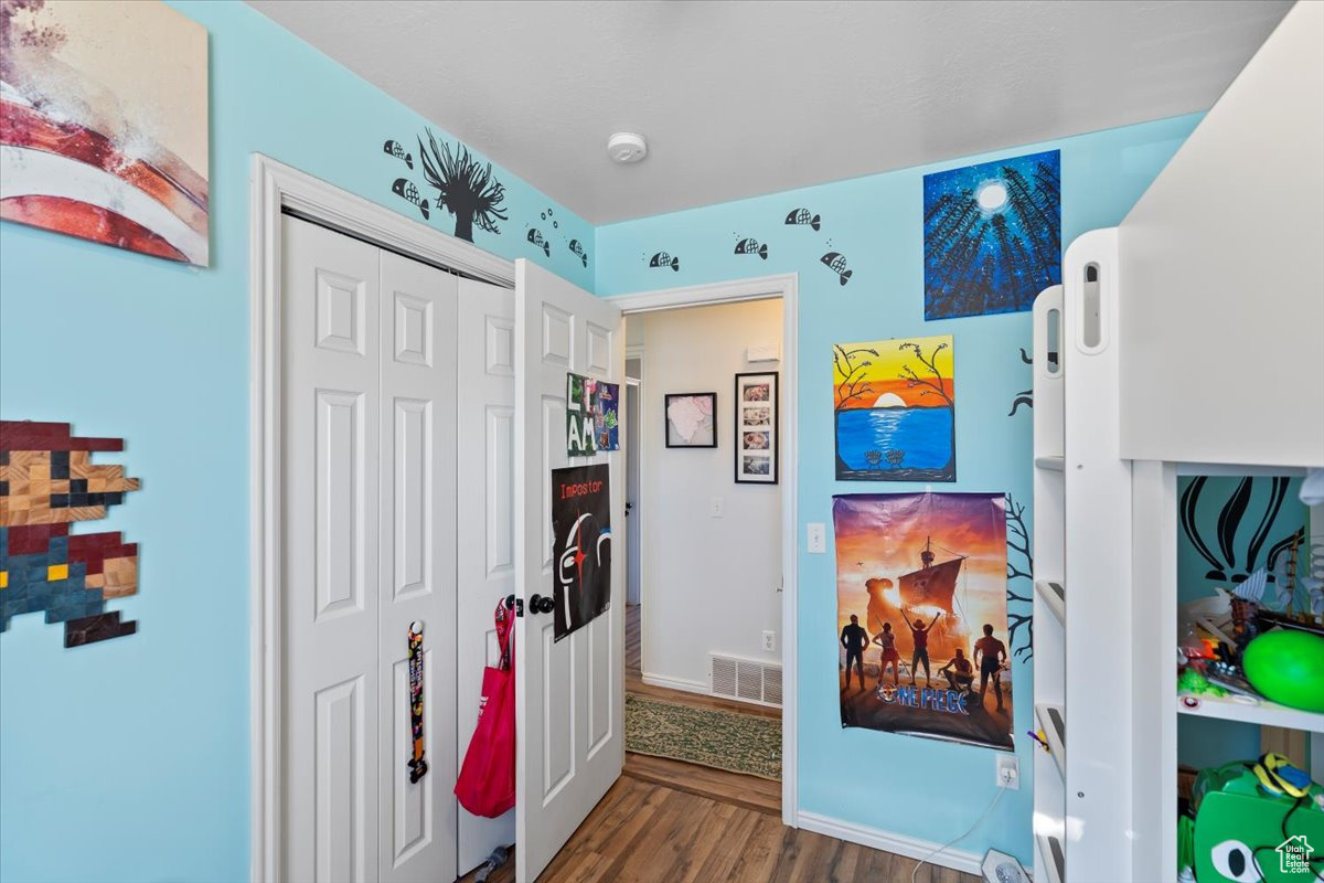 Interior space featuring dark wood-type flooring and a closet