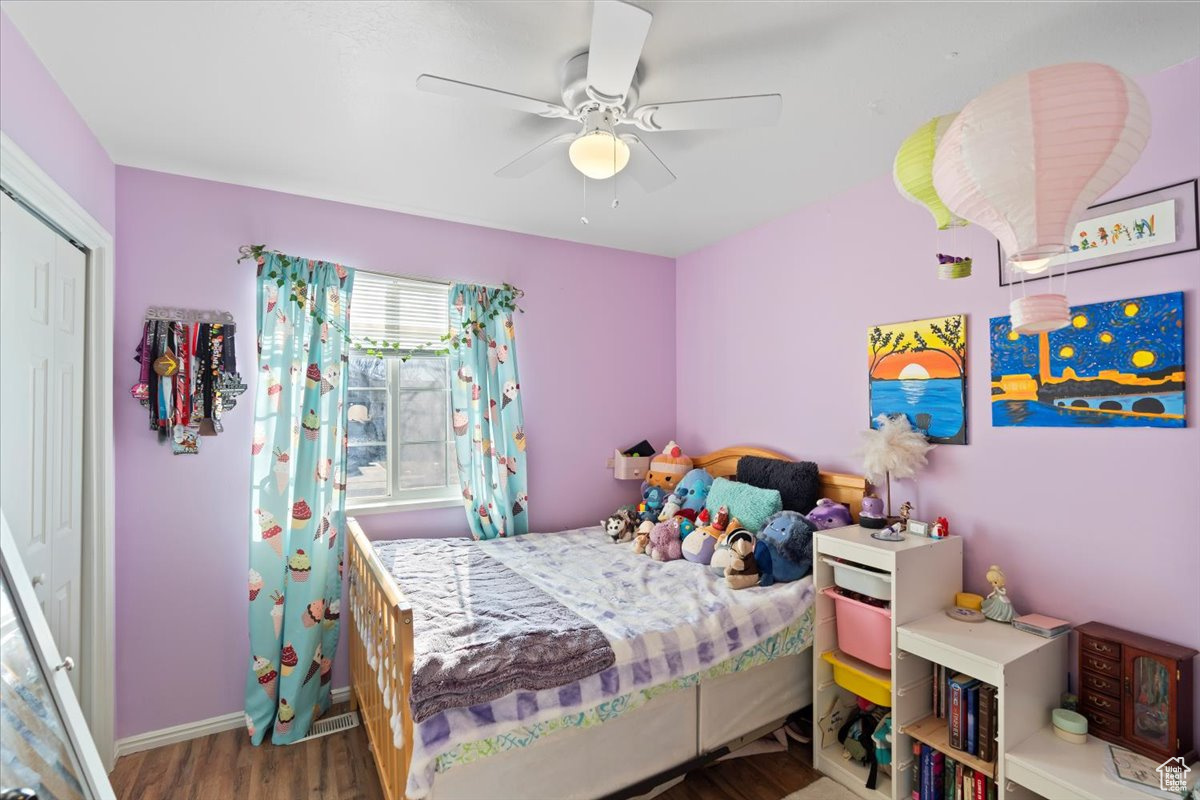 Bedroom featuring ceiling fan, a closet, and hardwood / wood-style floors