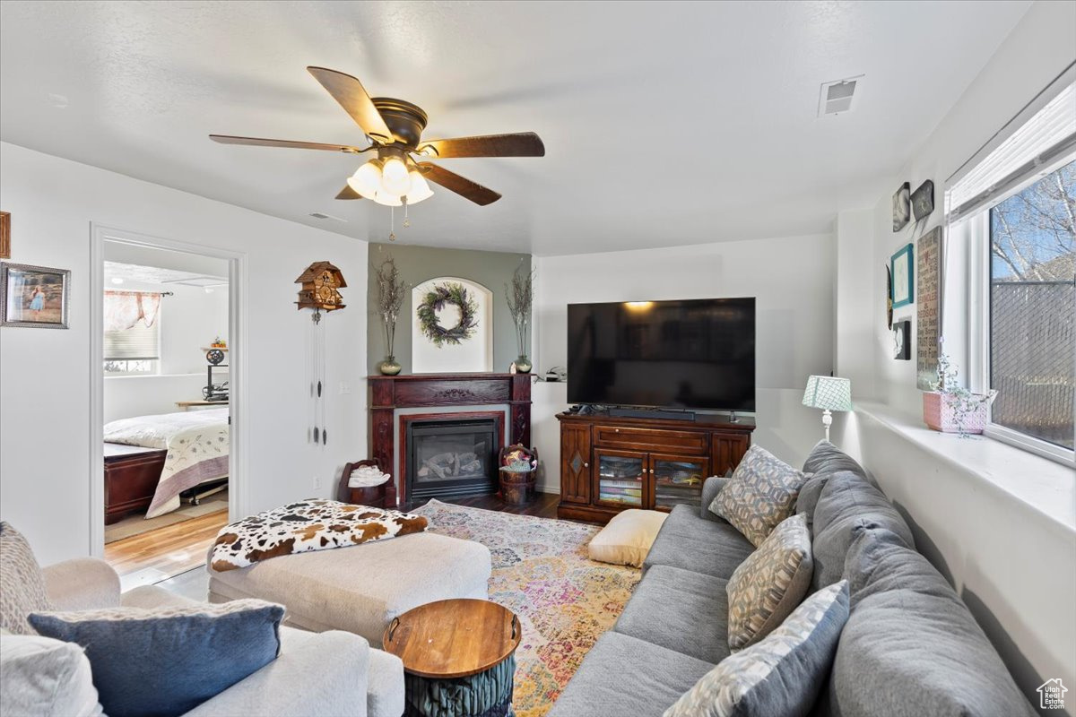 Living room featuring light hardwood / wood-style floors and ceiling fan