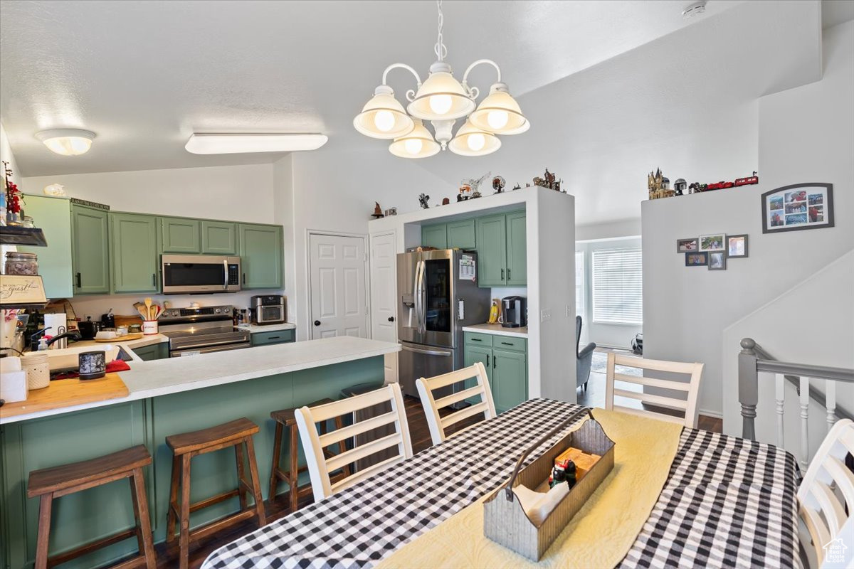 Dining space featuring lofted ceiling, sink, and a chandelier