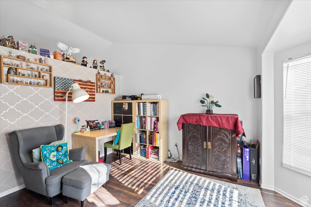 Interior space with vaulted ceiling and wood-type flooring