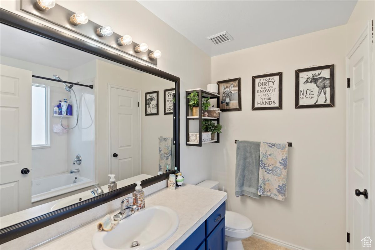 Full bathroom featuring toilet, vanity, and  shower combination