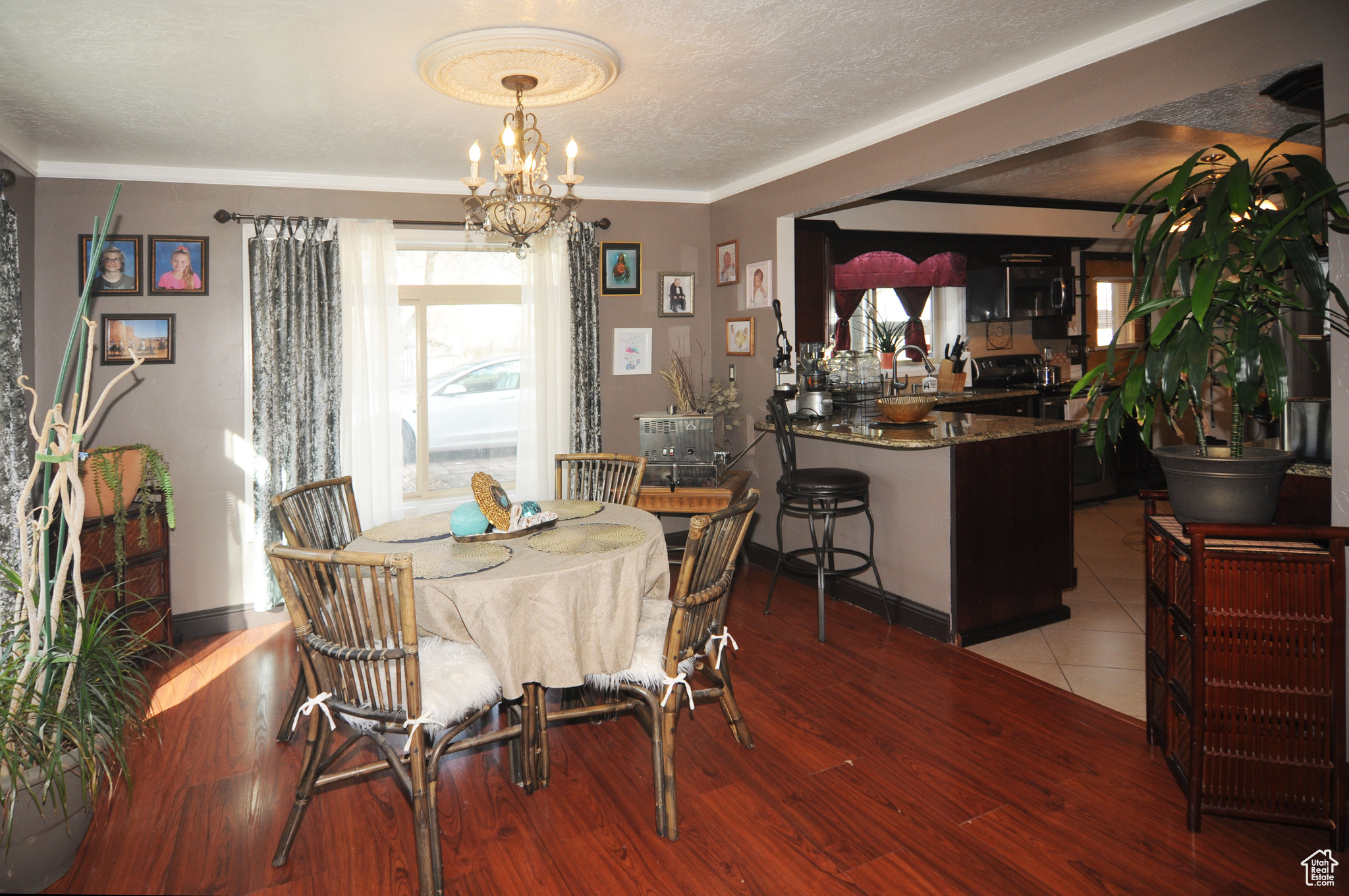Dining area featuring a textured ceiling, light hardwood / wood-style flooring, and an inviting chandelier
