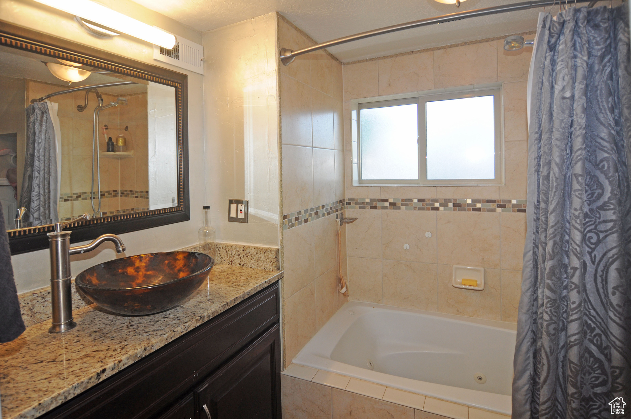 Master bathroom with vanity and shower / bath combo