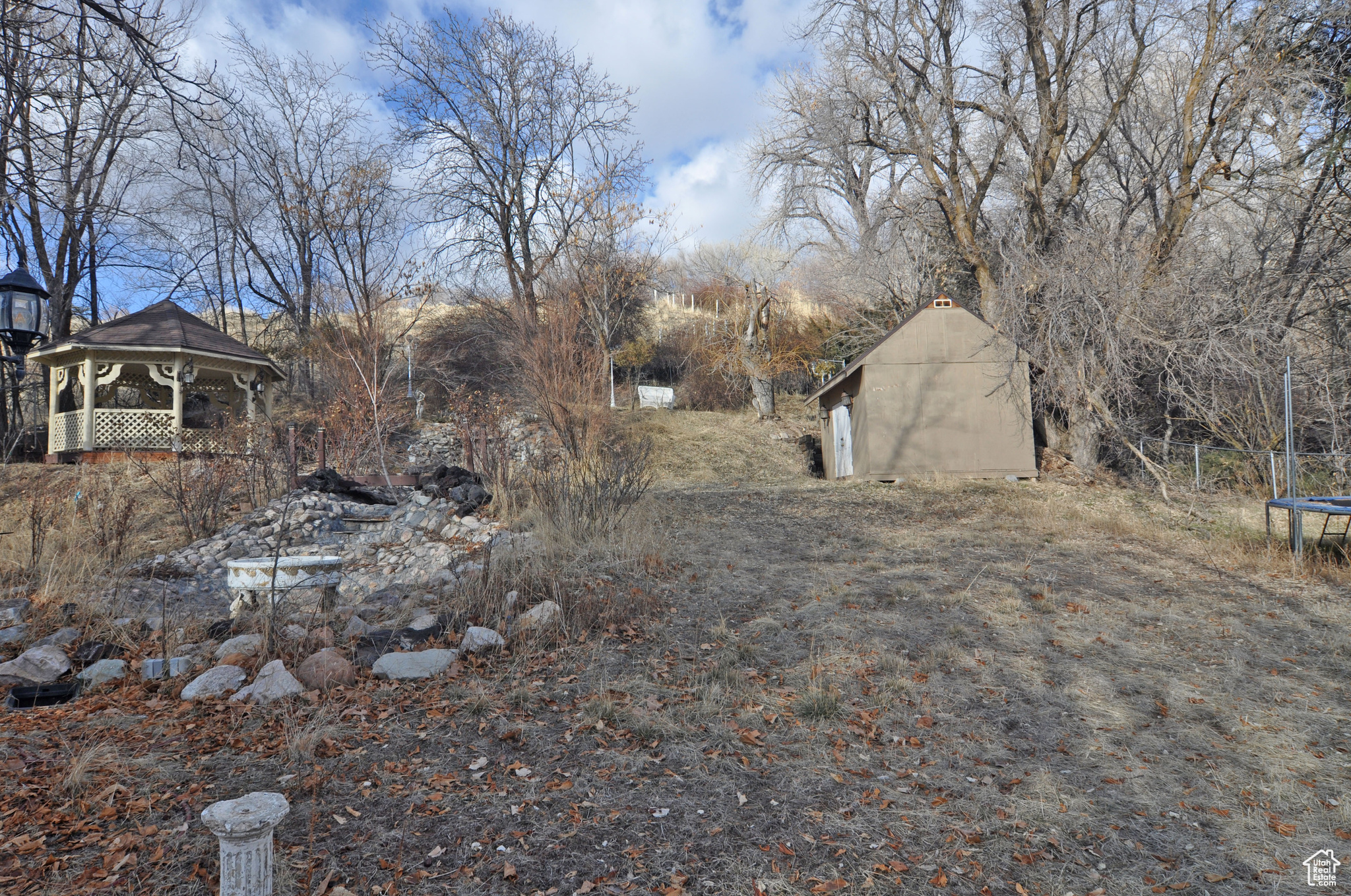View of yard featuring a gazebo and a storage unit