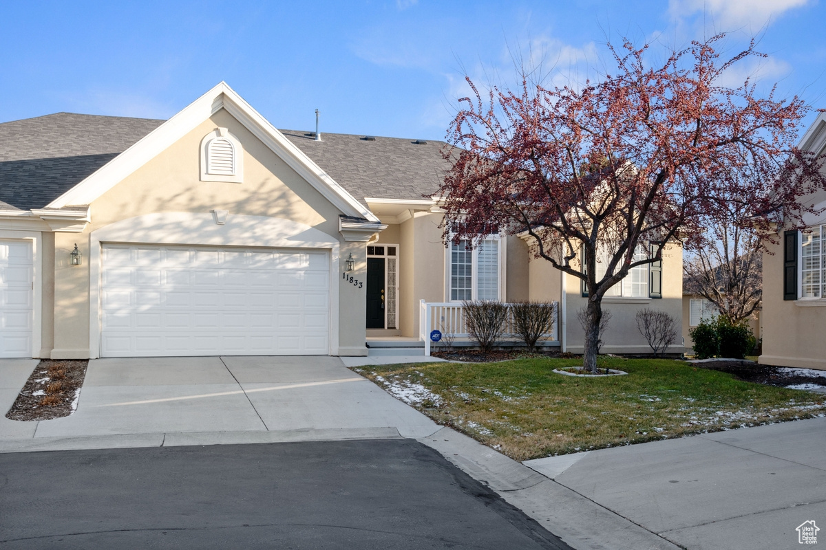 View of front of house with a front lawn and a garage