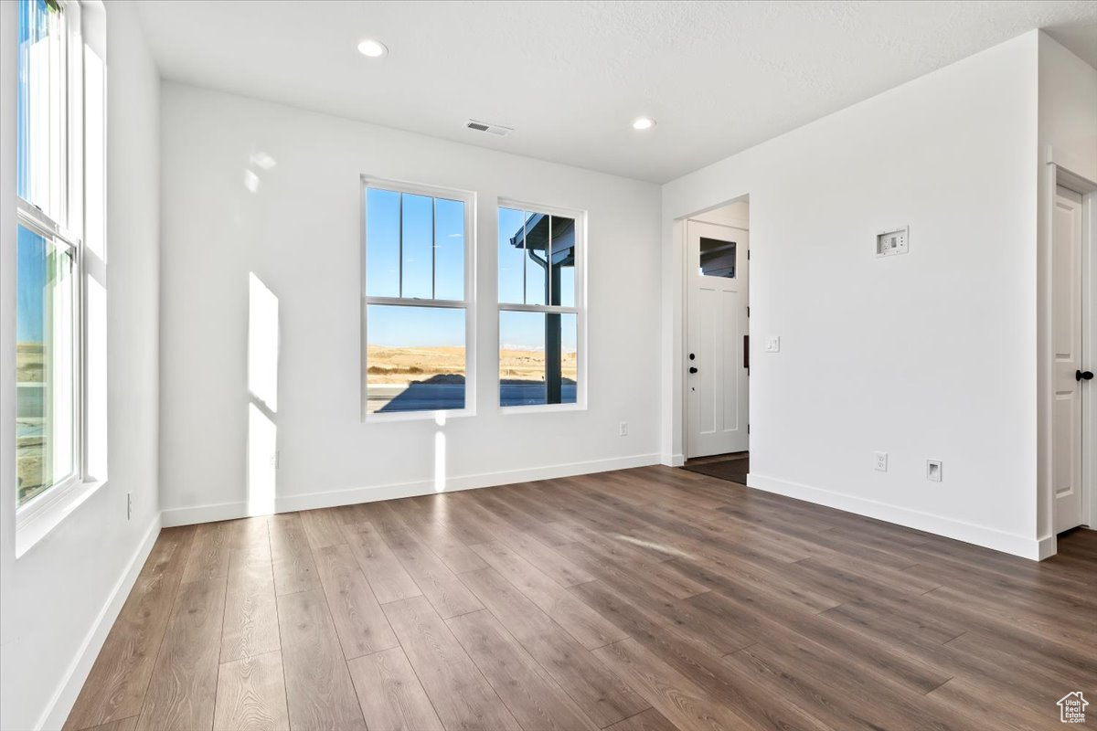 Unfurnished room with dark hardwood / wood-style floors