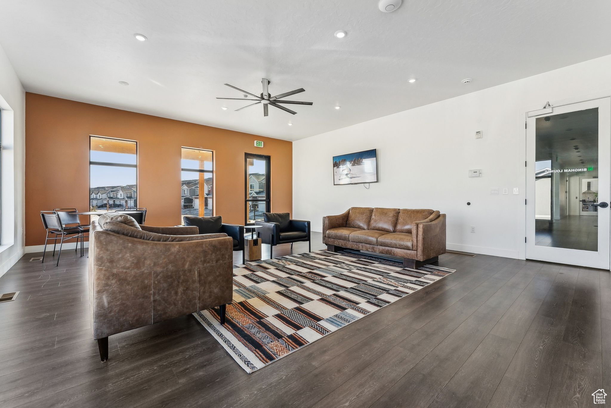 Living room featuring ceiling fan and dark hardwood / wood-style floors