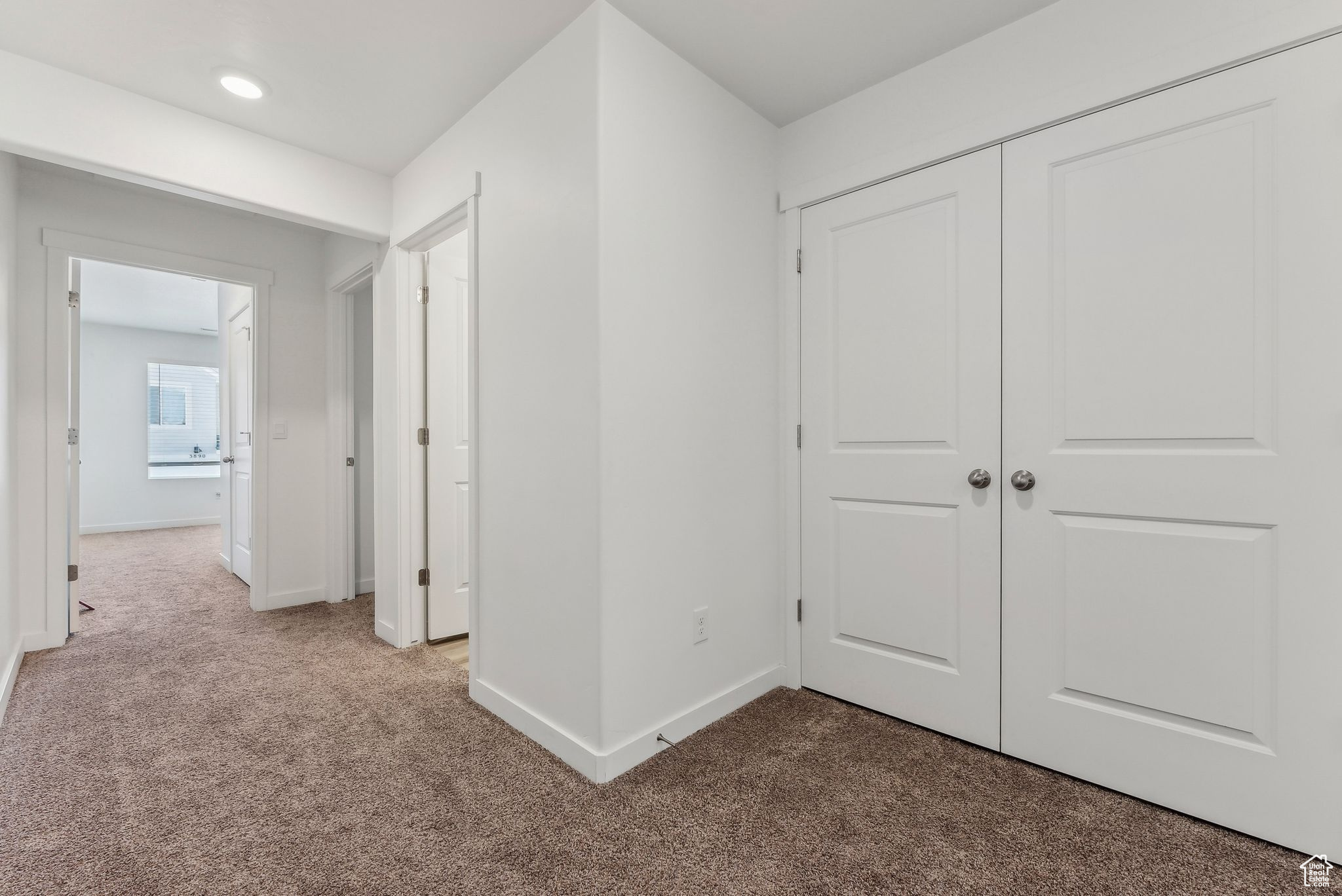 Hallway featuring carpet floors