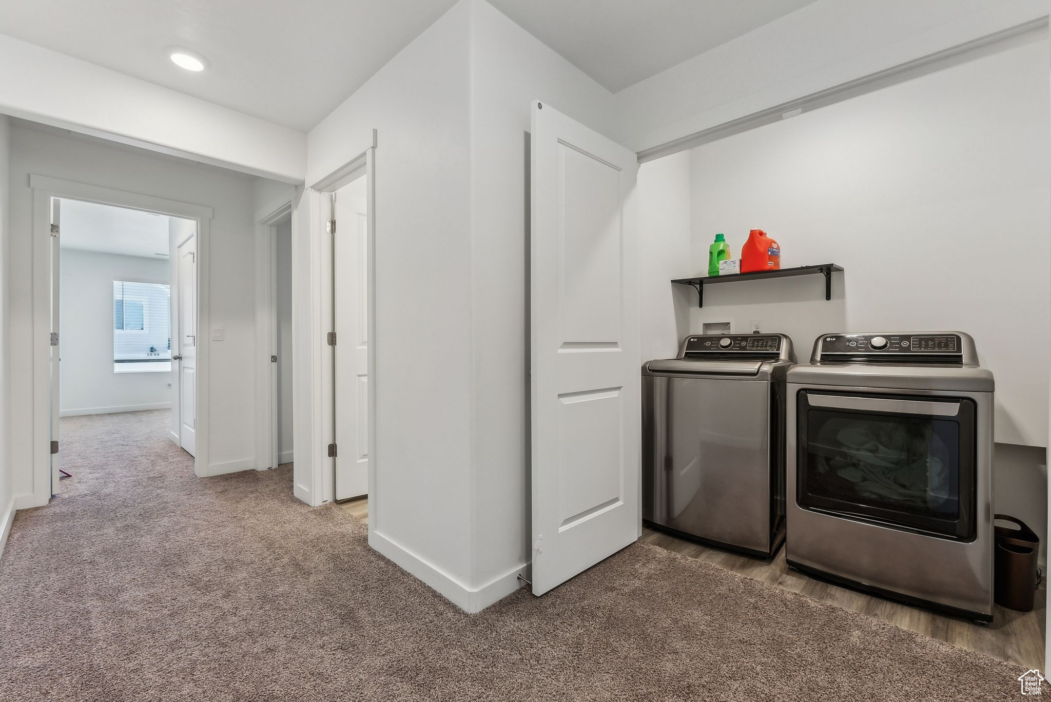 Washroom featuring light carpet and separate washer and dryer