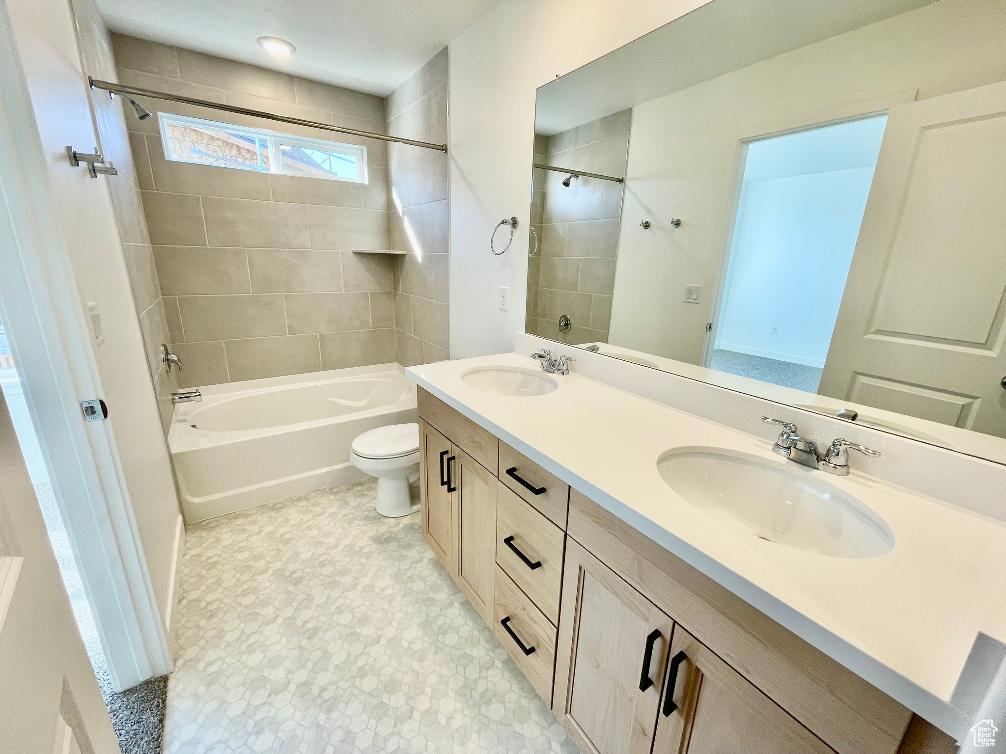 Full bathroom featuring vanity, toilet, and tiled shower / bath combo