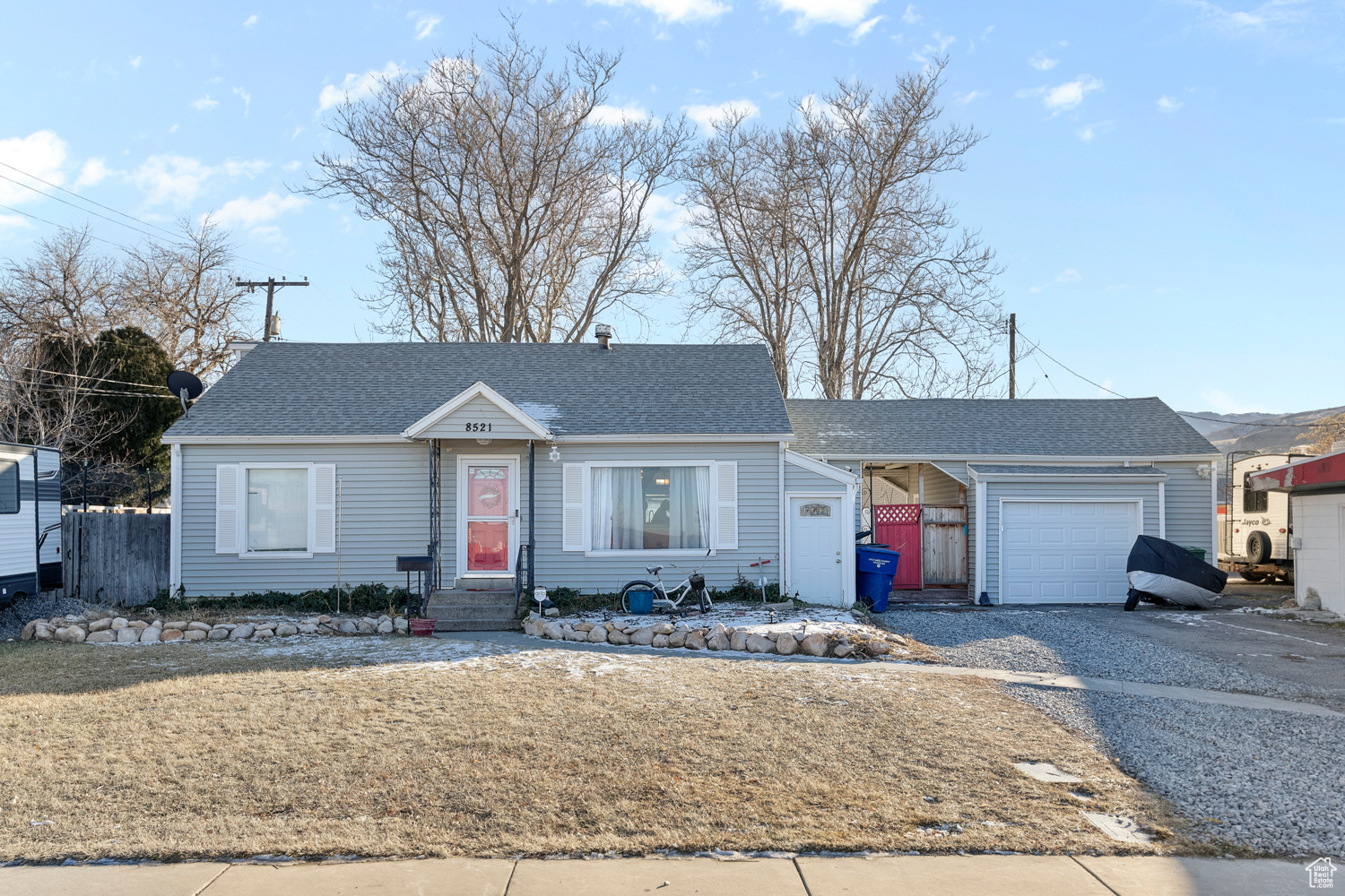 Single story home featuring a front yard and a garage