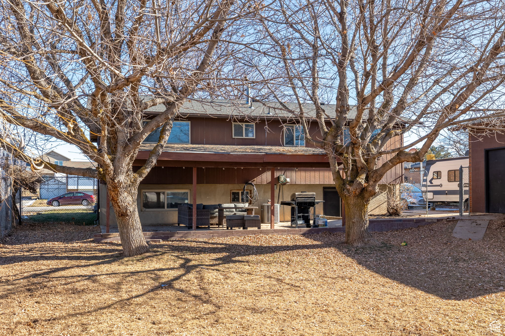 Back of property featuring an outdoor living space and a patio