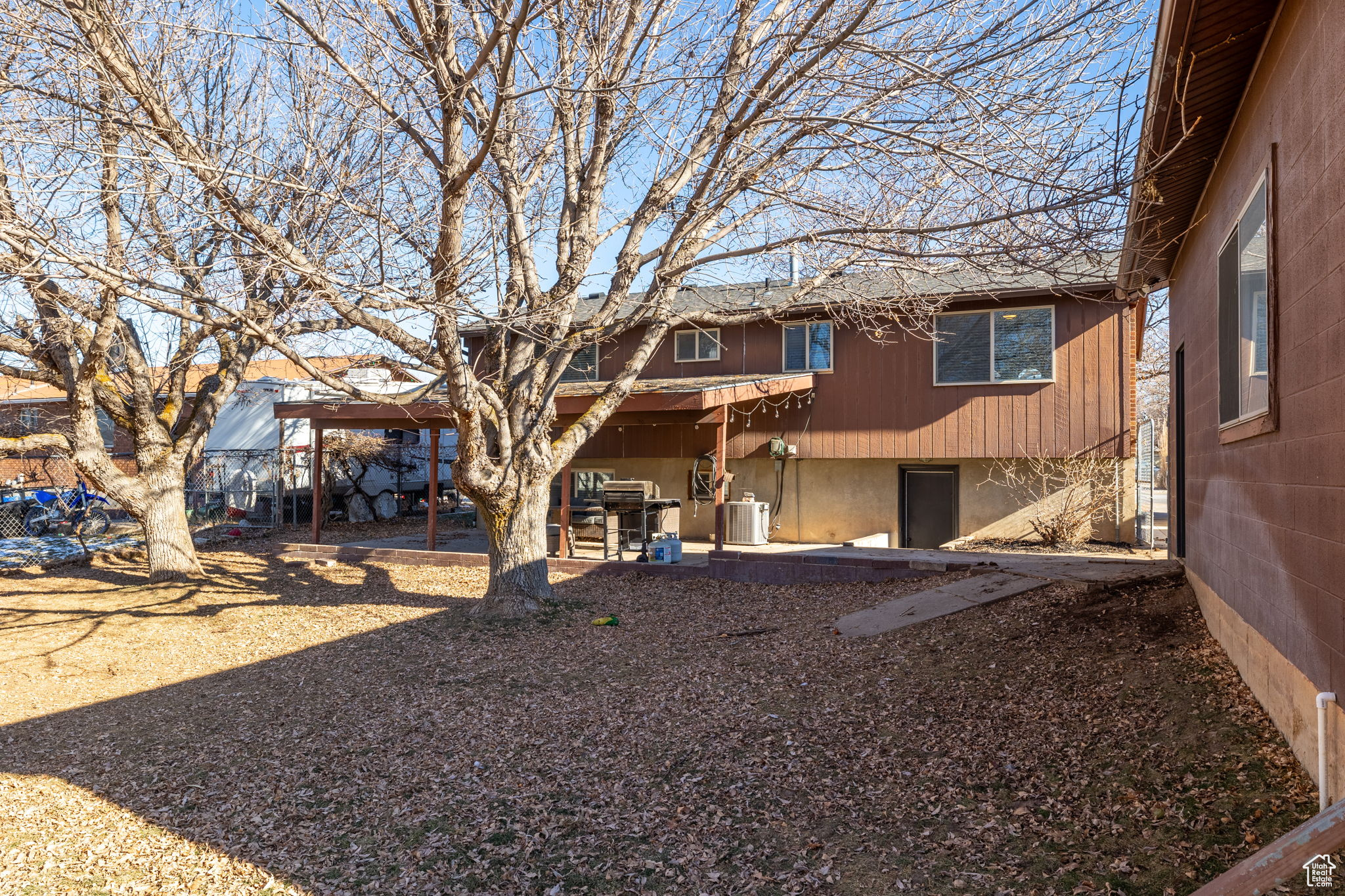 Rear view of property with central air condition unit and a patio area