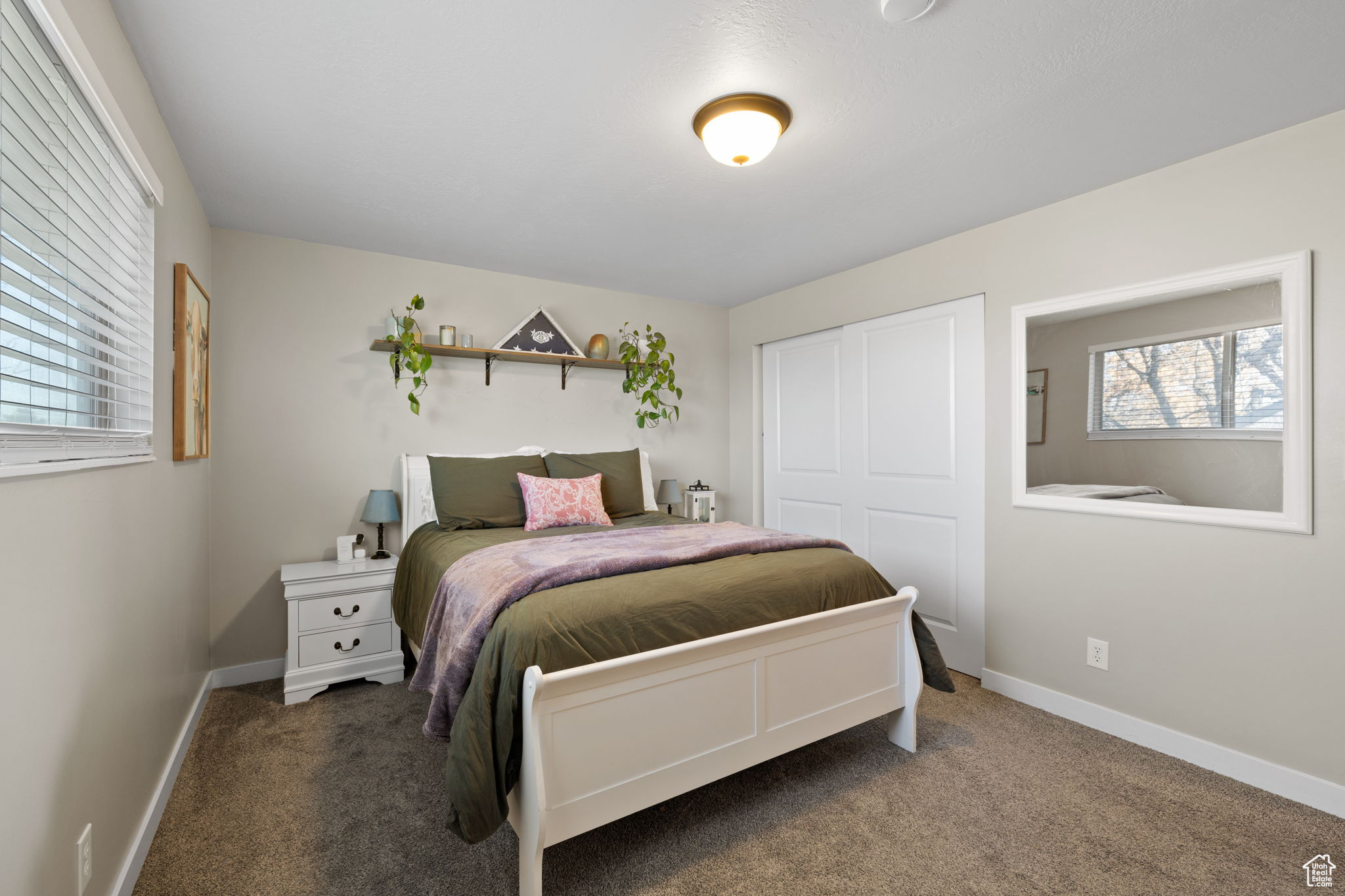 Carpeted bedroom with a closet