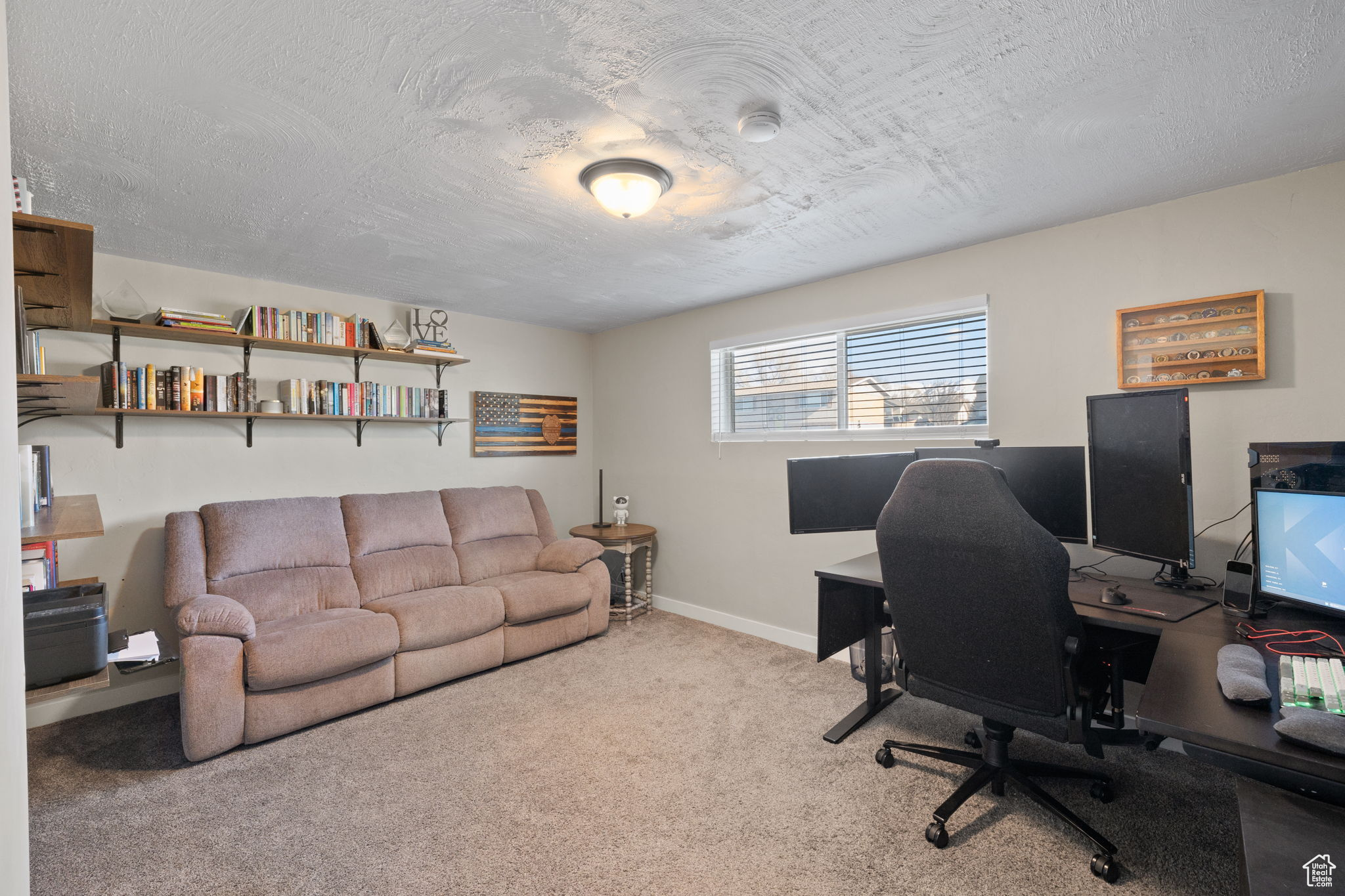 Carpeted office with a textured ceiling