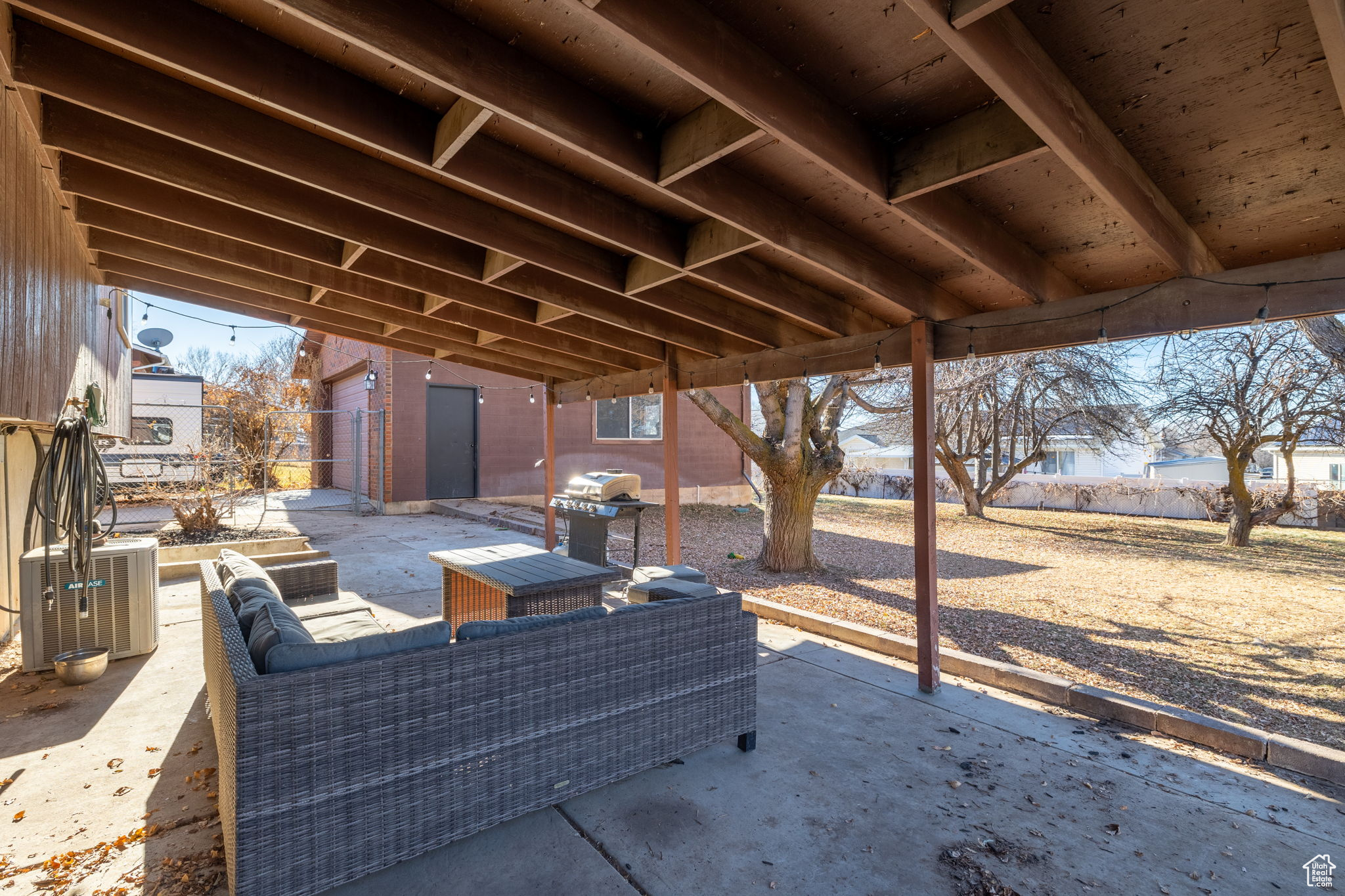 View of patio / terrace featuring area for grilling, central AC unit, an outdoor hangout area, and a storage shed