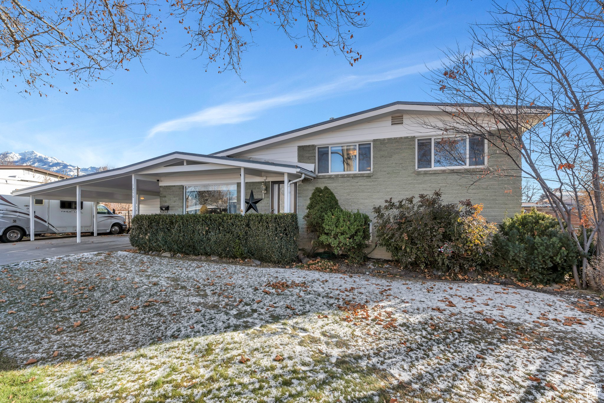 View of front of property with a carport