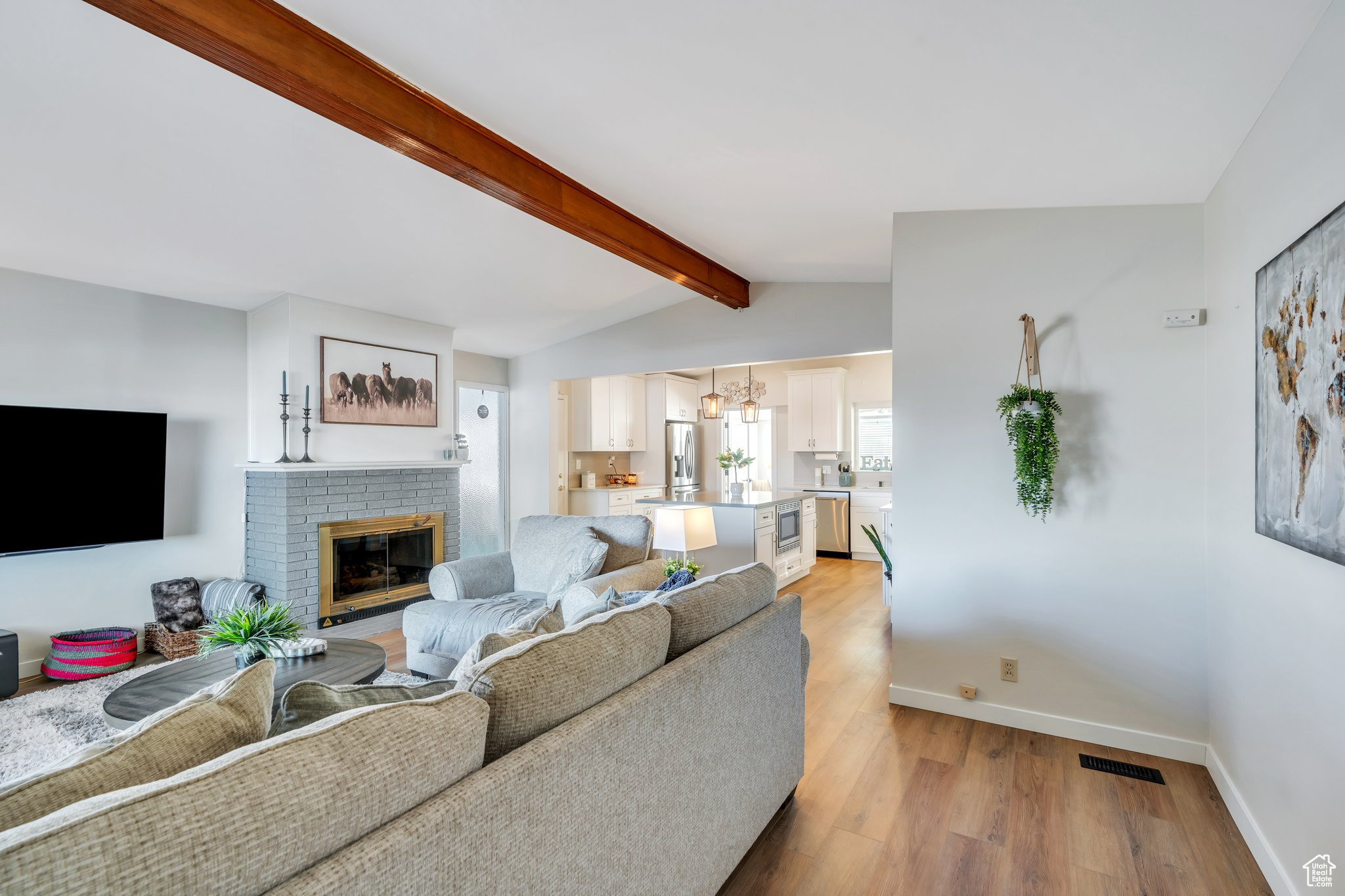 Living room with vaulted ceiling, and fireplace