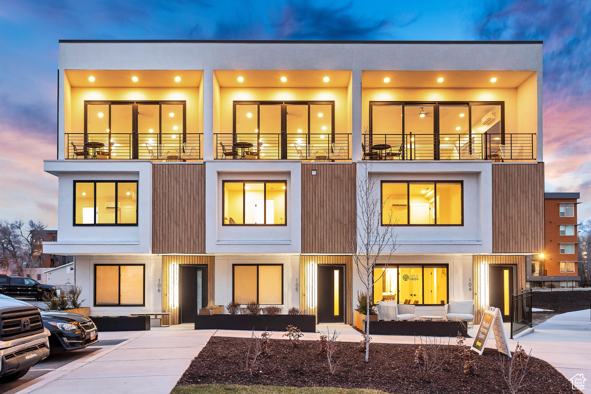 Back house at dusk with a balcony