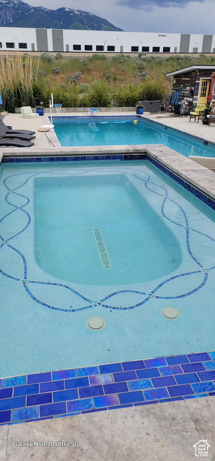 View of swimming pool with a mountain view