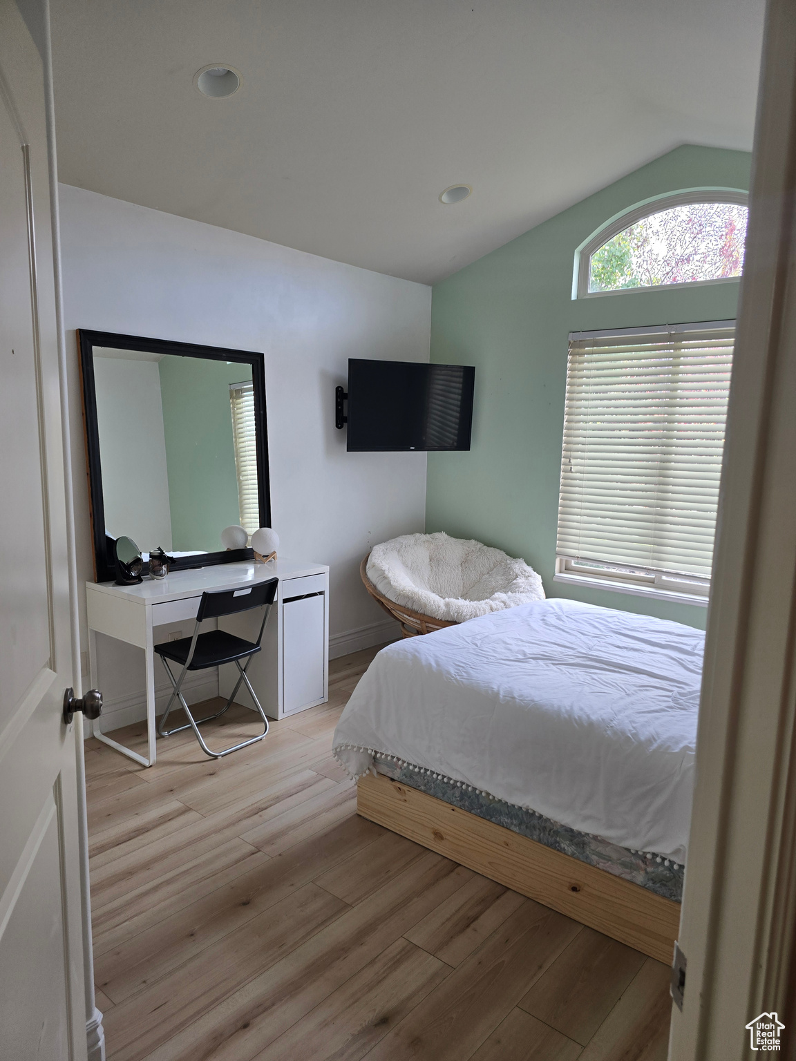 Bedroom with lofted ceiling and light hardwood / wood-style floors