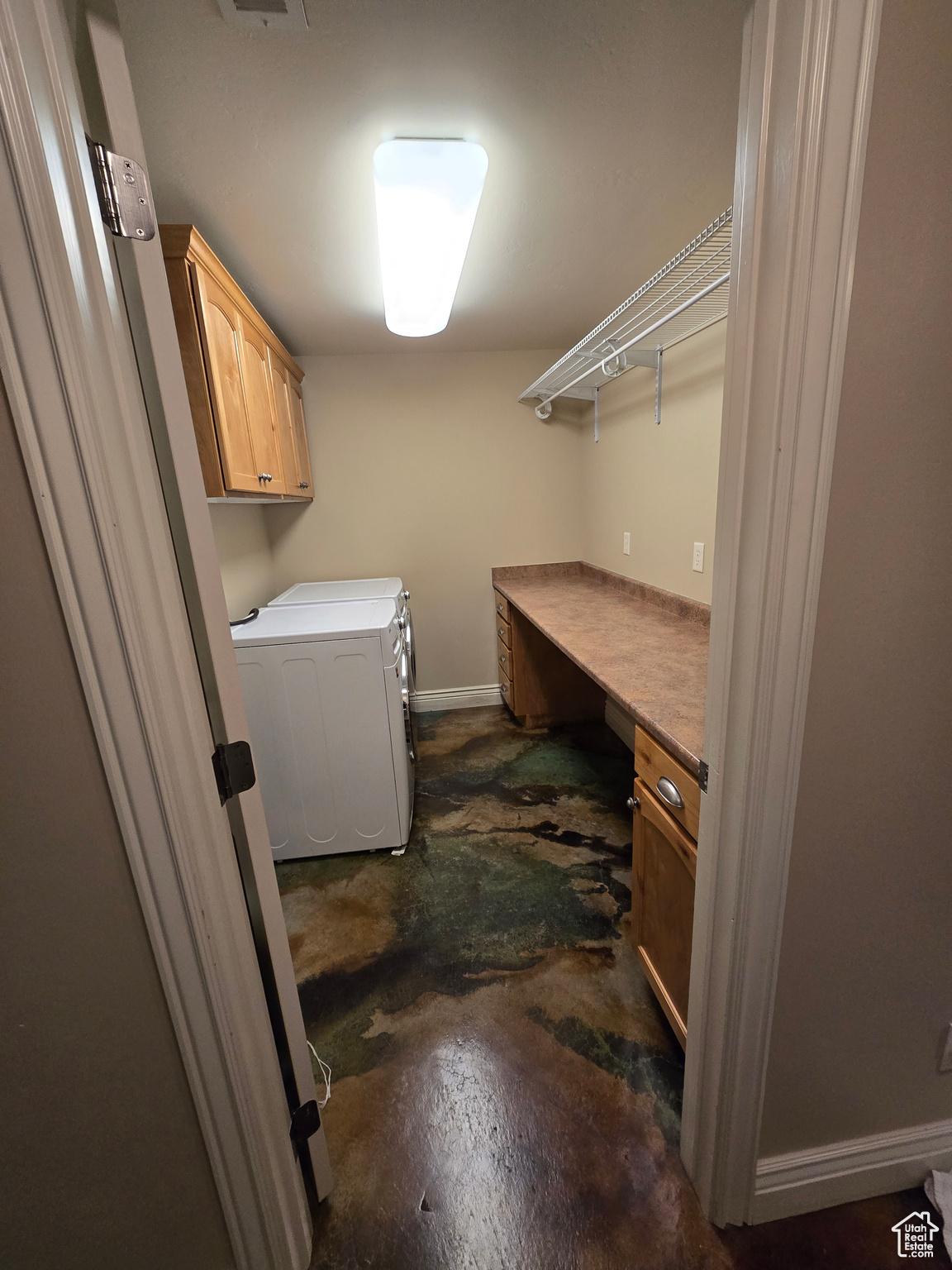 Laundry area featuring cabinets and separate washer and dryer