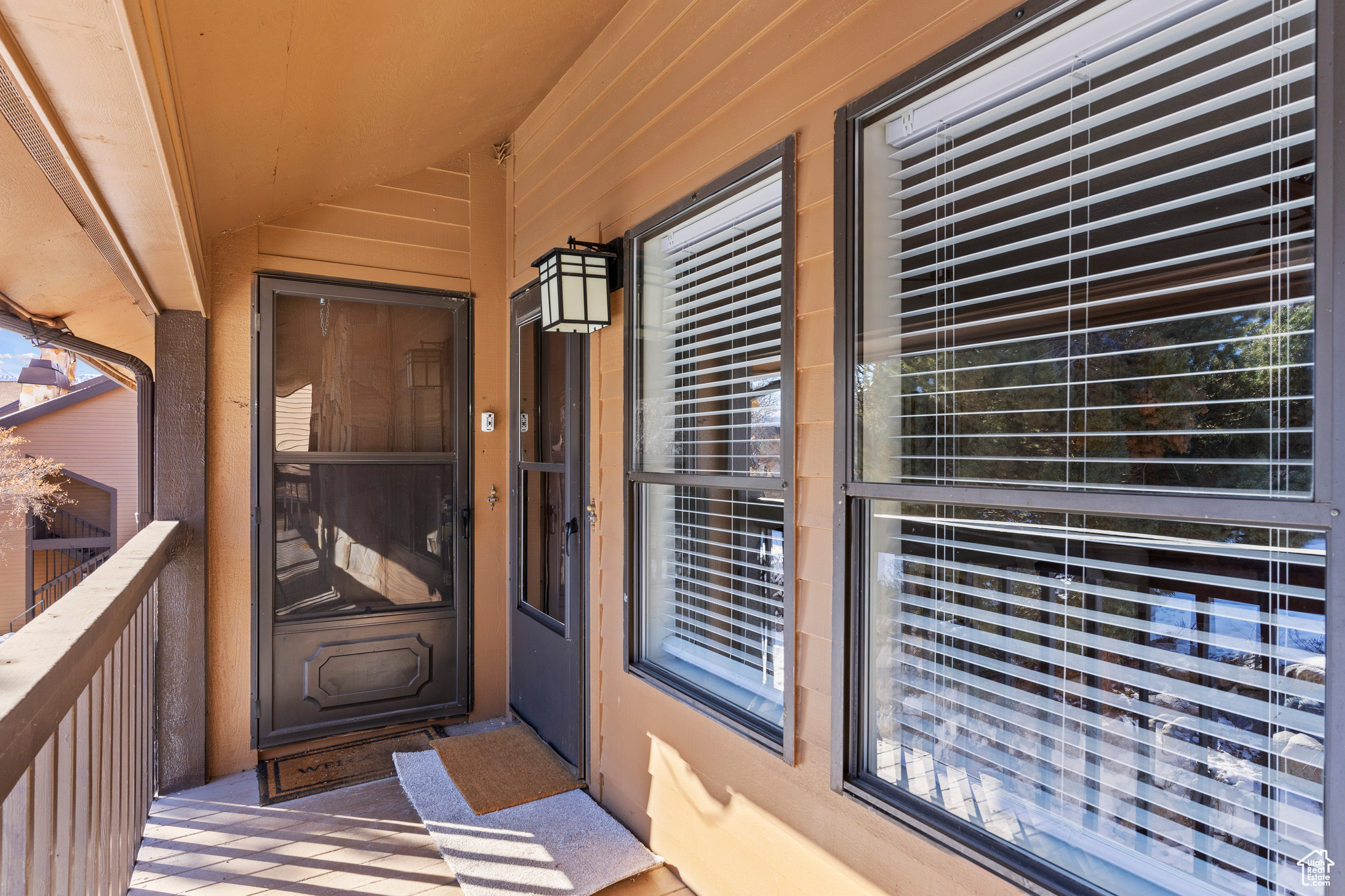 View of exterior entry featuring a balcony