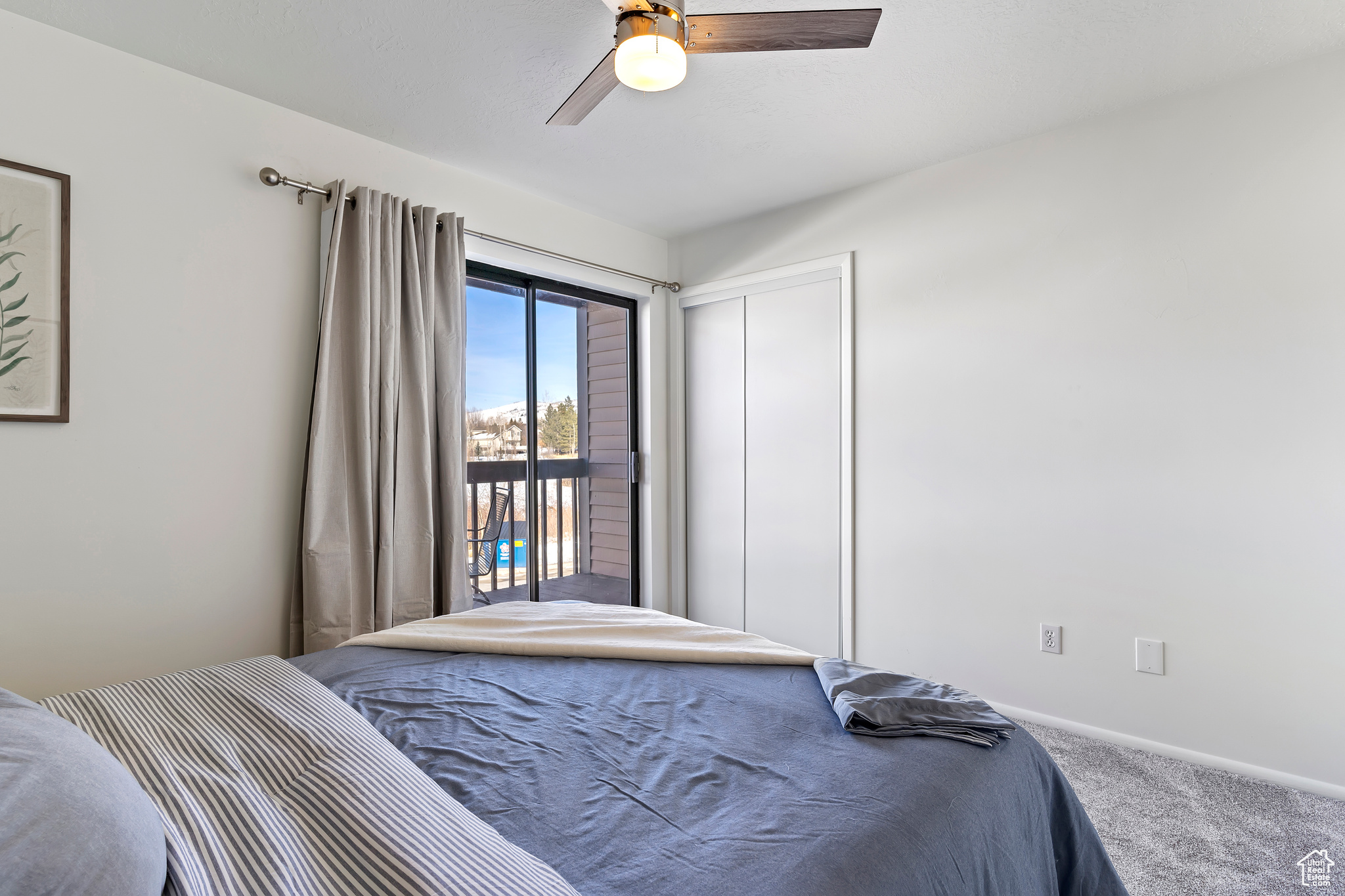 Carpeted bedroom with access to outside, ceiling fan, and a closet